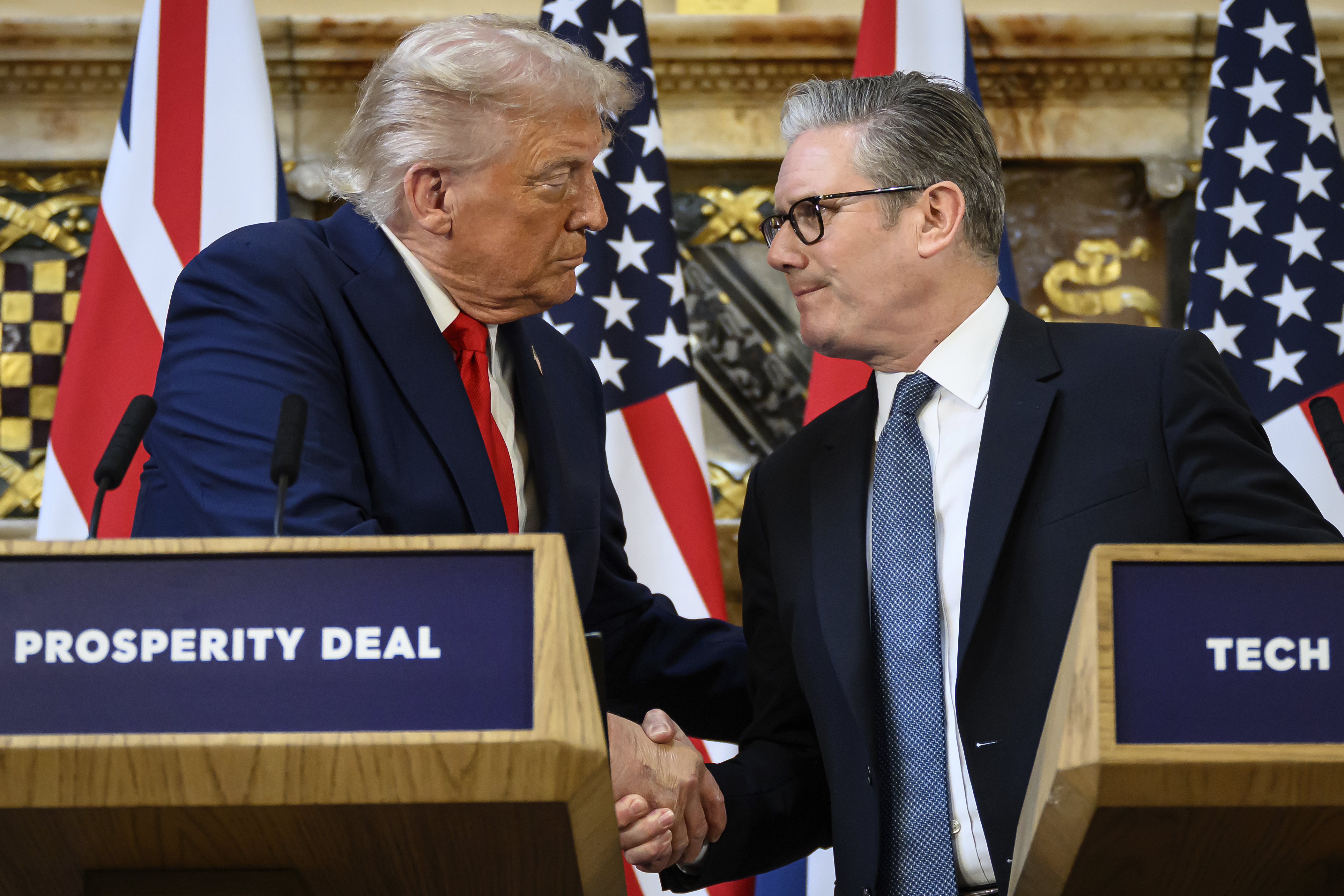U.S. President Donald Trump, left, and British Prime Minister Keir Starmer look at each other as they shake hands during a press conference at Chequers near Aylesbury, England, Thursday Sept. 18, 2025, at the conclusion of President Trump's second UK state visit, with the previous one taking place in 2019 during his first presidential term. (Leon Neal - Pool Getty)