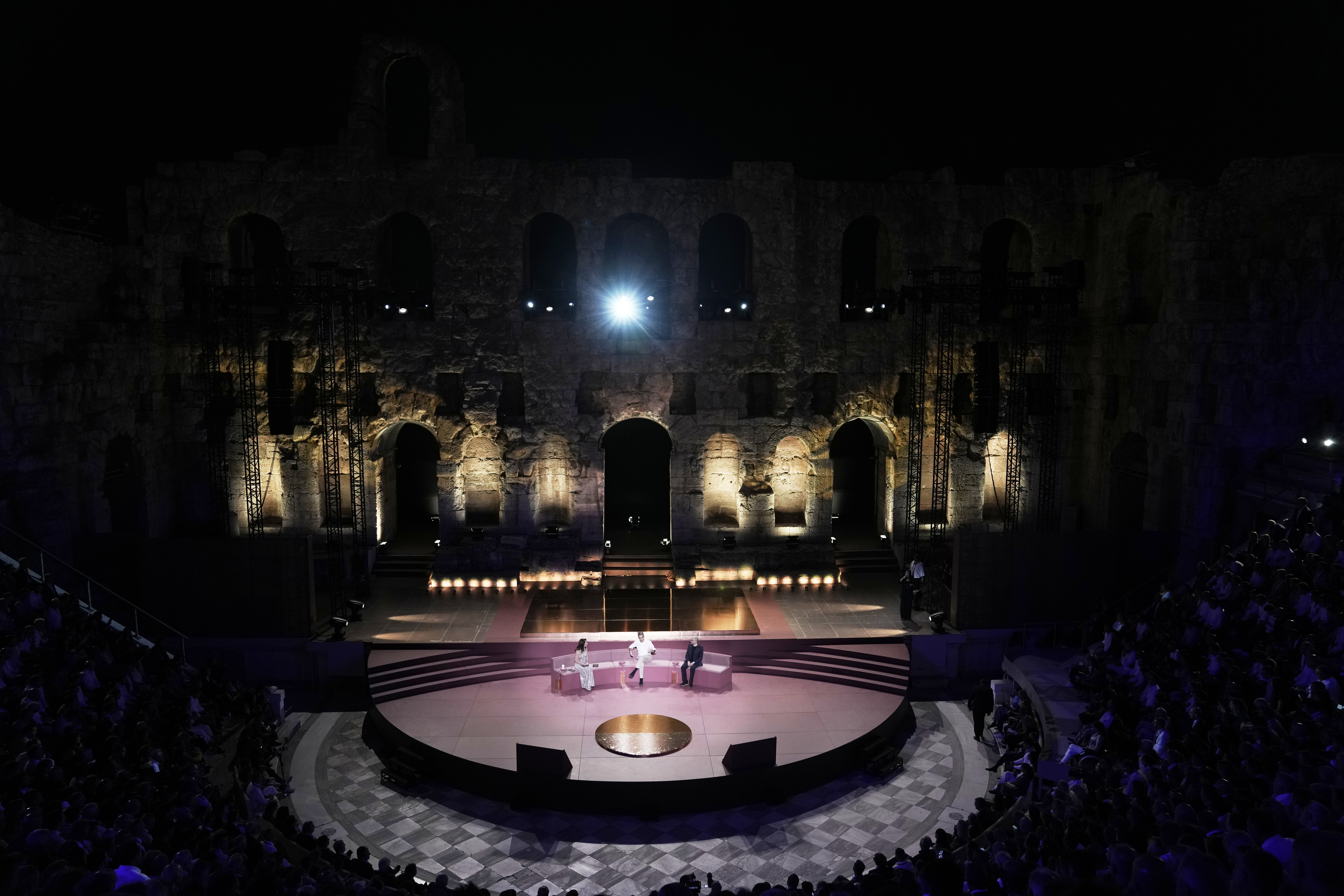 Greece's Prime Minister Kyriakos Mitsotakis, center, and Demis Hassabis, CEO of Google's artificial intelligence research company DeepMind, right, discuss the future of AI, ethics and democracy as the moderator Linda Rottenberg, Co-founder & CEO of Endeavor looks on during an event at the Odeon of Herodes Atticus in Athens, Greece, Friday, Sept. 12, 2025. (Thanassis Stavrakis - AP)