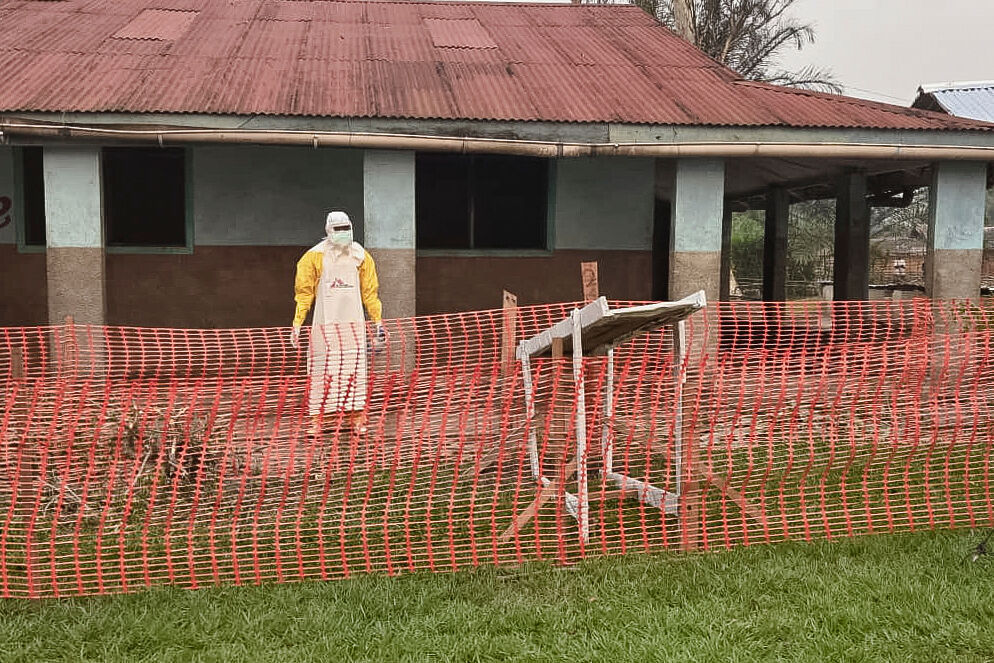 In this photo provided by Doctors Without Borders, a man wearing protective clothing stands outside an Ebola treatment center in the remote Bulape Health Zone, Kasaï province, the Democratic Republic of Congo, Sunday, Sept 7, 2025, that was set up following the outbreak of the Zaire strain of the Ebola virus. (Uncredited - Médecins Sans Frontières)