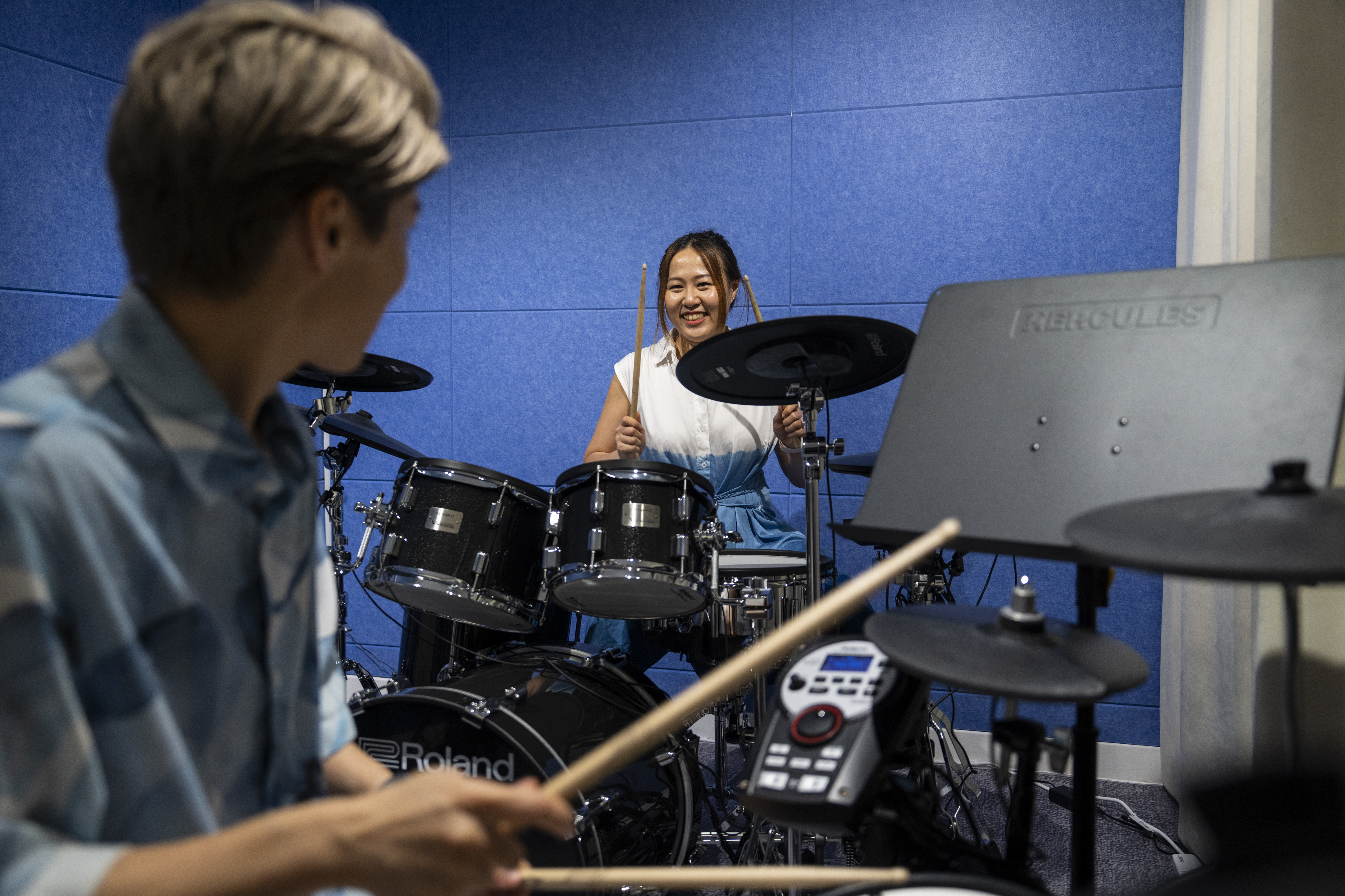 Same-sex partners Jaedyn Yu, left, and Gloria Tsang play drums in a band room in Hong Kong, Sunday, Aug. 24, 2025. (Chan Long Hei - AP)