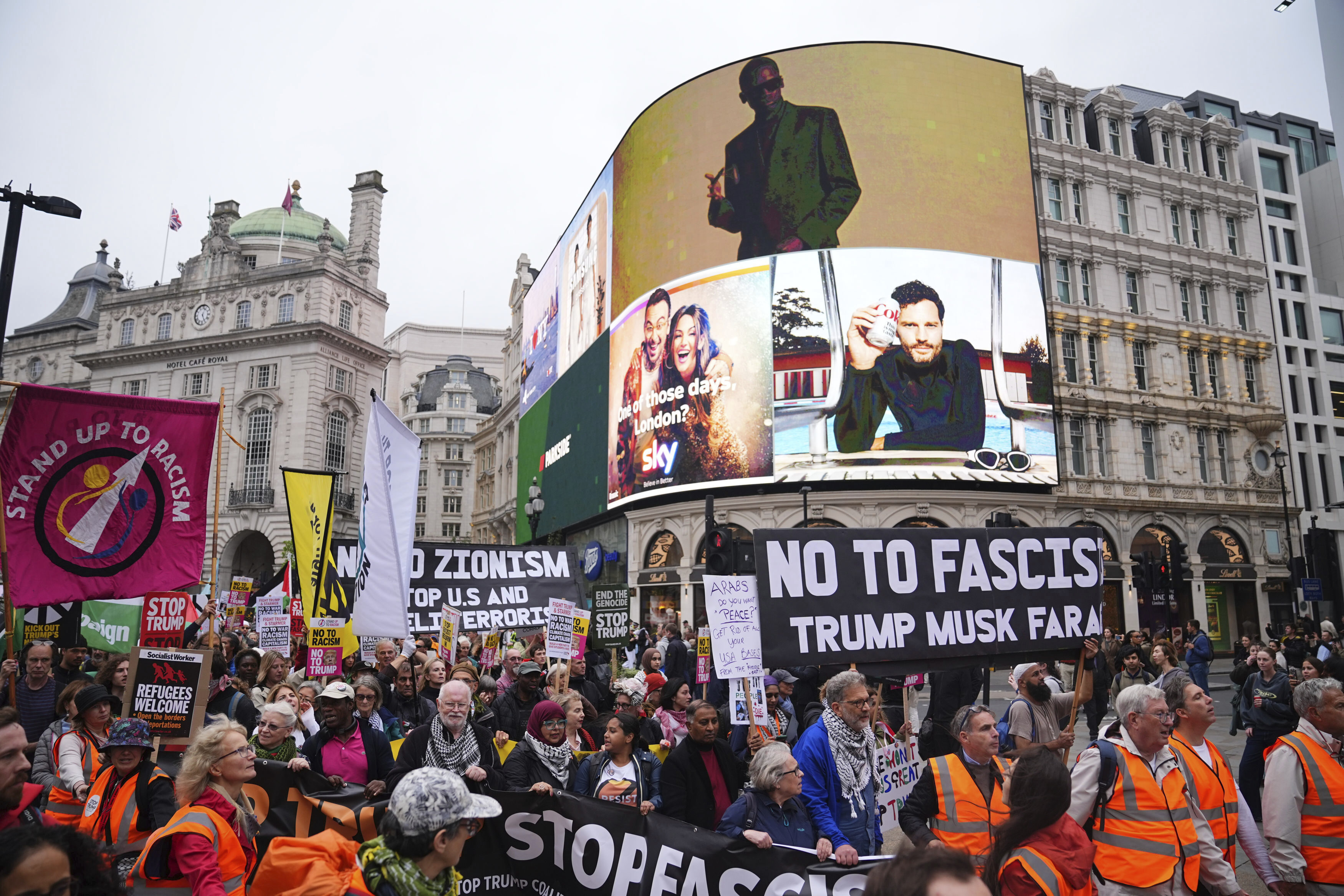 Campaigners hold signs and wave Palestinian flags during a Stop Trump Coalition protest march from Portland Place to Parliament Square in London, Wednesday Sept. 17, 2025. (James Manning - PA)