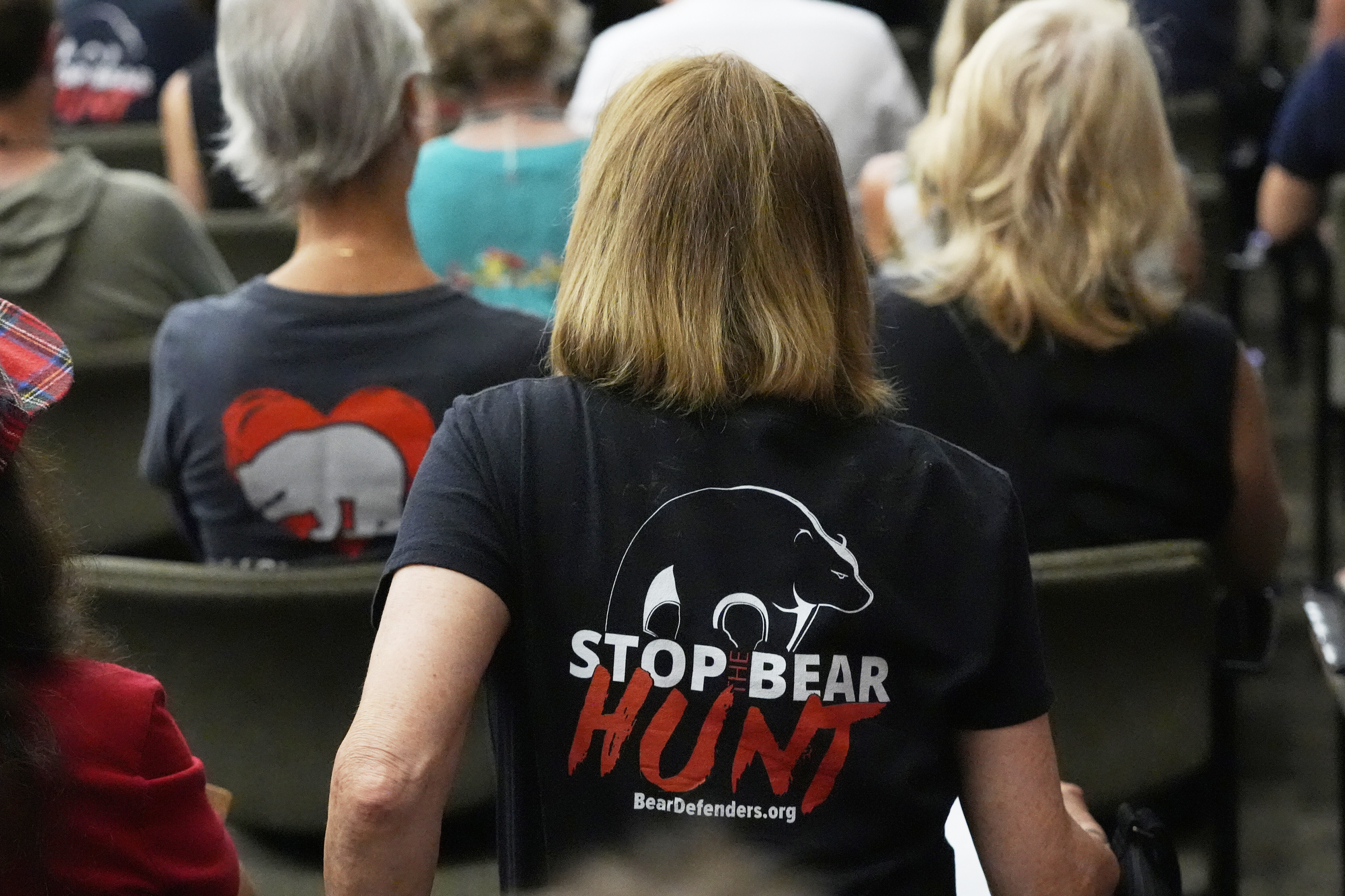 FILE - Citizens attending a Florida Fish & Wildlife Commission hearing about proposed bear hunting wear t-shirts against legalized bear hunting in the state, May 21, 2025, in Ocala, Fla. (John Raoux - AP)