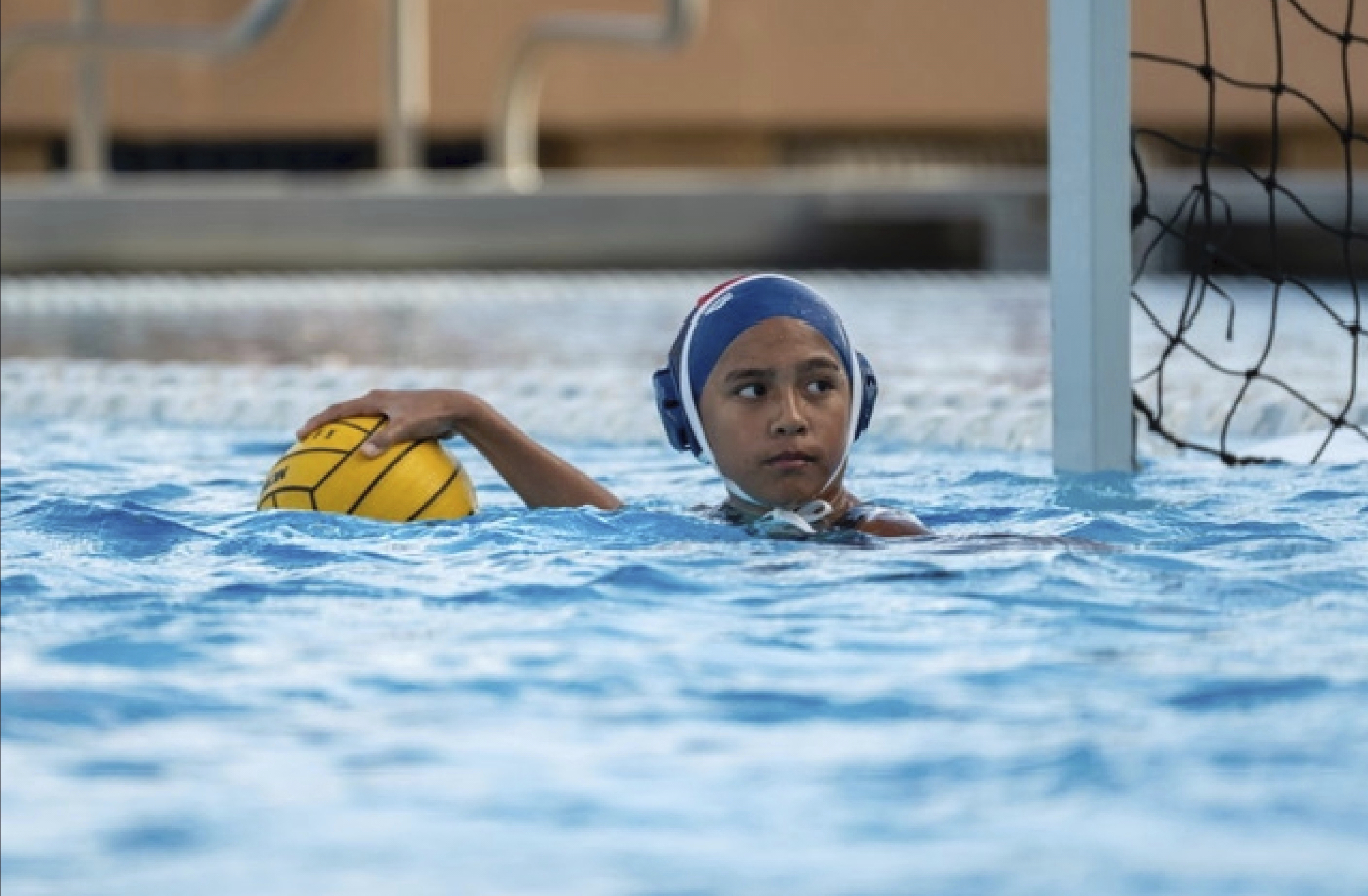 Goalie Kapua Ong controls the ball during a Kamehameha Schools water polo match on Thursday, March 28, 2024, in Honolulu. (Tiffany Canonigo - Tiffany Canonigo)