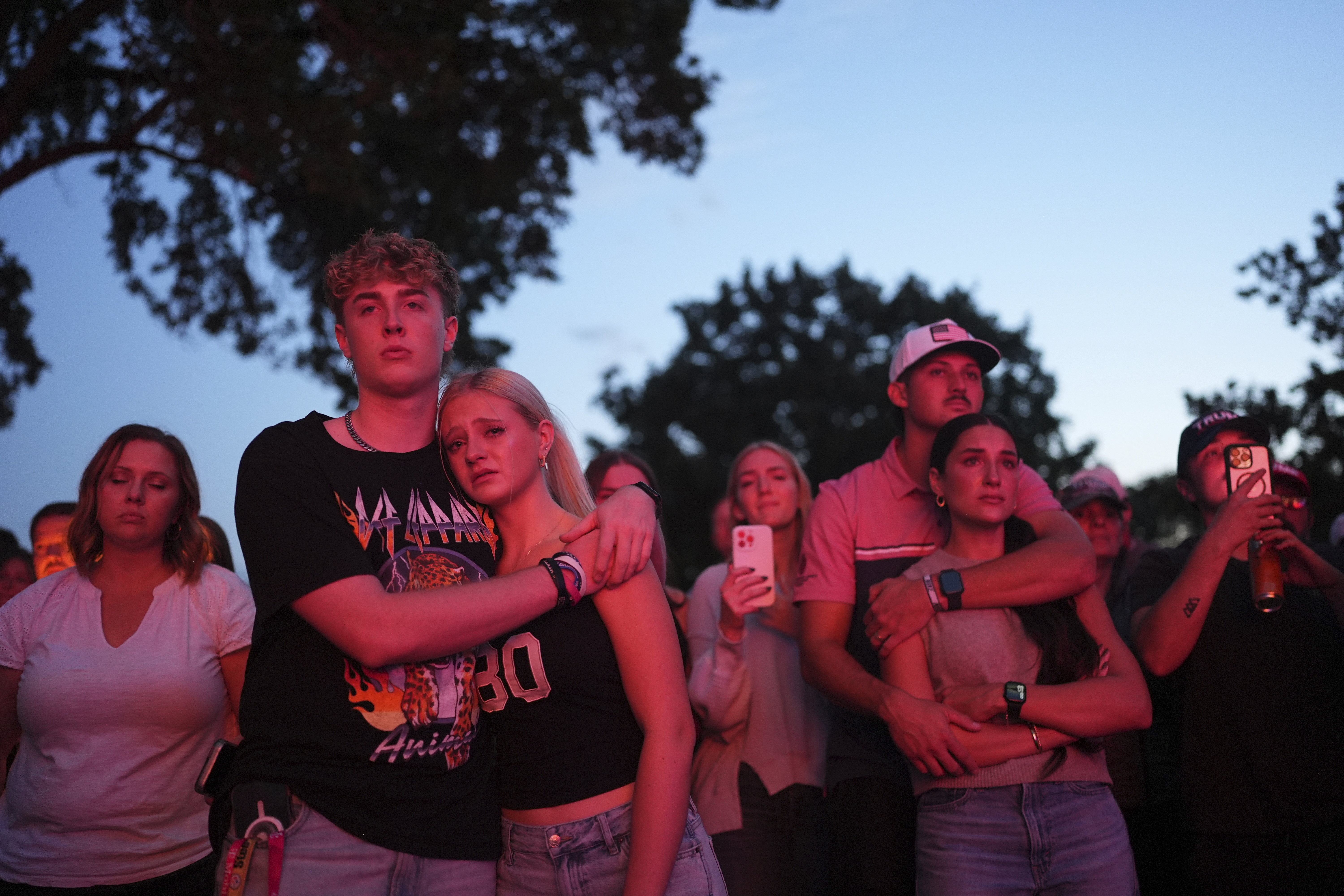 Utah Valley University students Zach Zimmerman, second from left, and Lauren Simons embrace during a vigil for Charlie Kirk, the CEO and co-founder of Turning Point USA who was shot and killed, Thursday, Sept. 11, 2025, in Orem, Utah. Zimmerman witnessed the shooting. (Lindsey Wasson - AP)