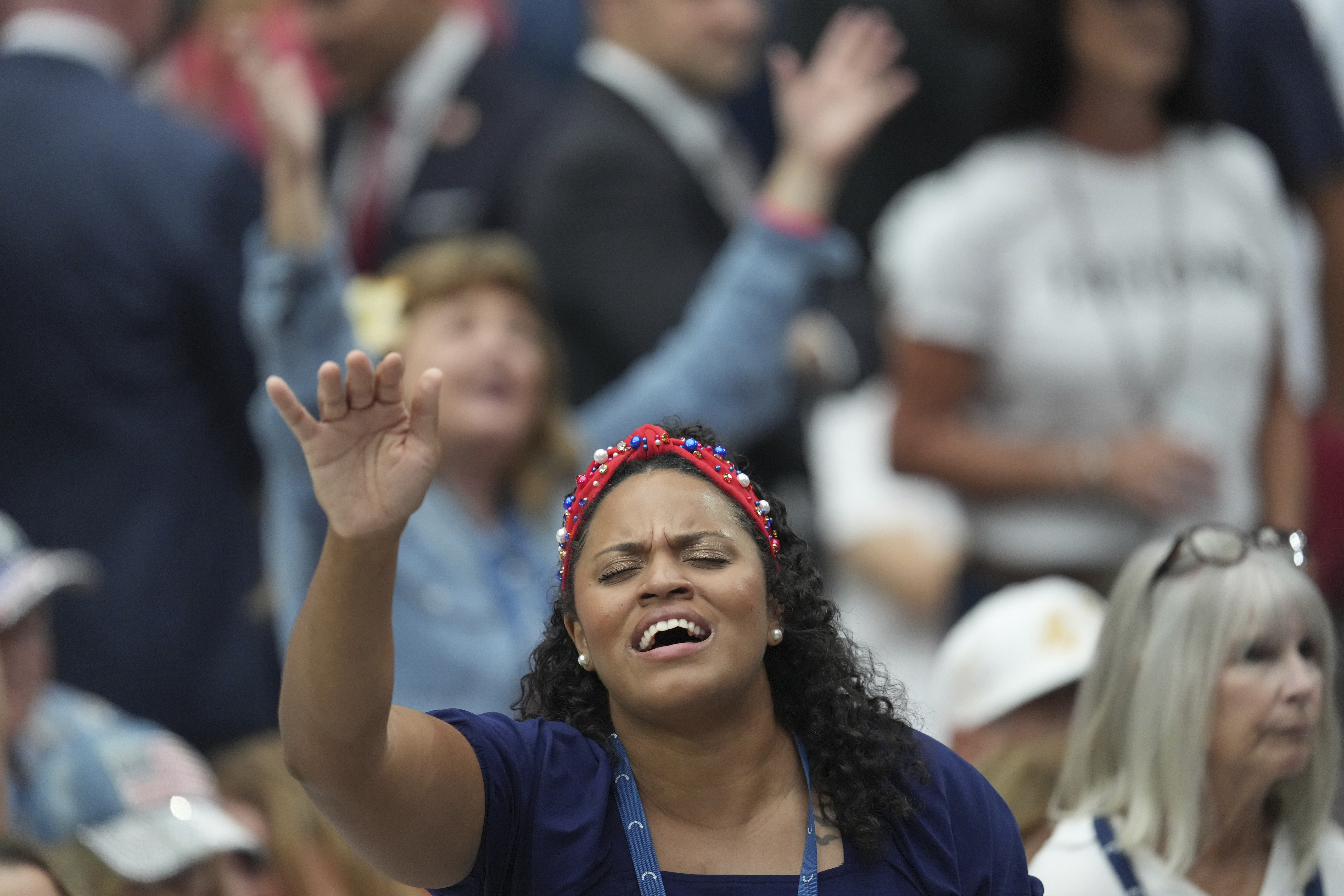 A supporter prays during a memorial for conservative activist Charlie Kirk, Sunday, Sept. 21, 2025, at State Farm Stadium in Glendale, Ariz. (Ross D. Franklin - AP)