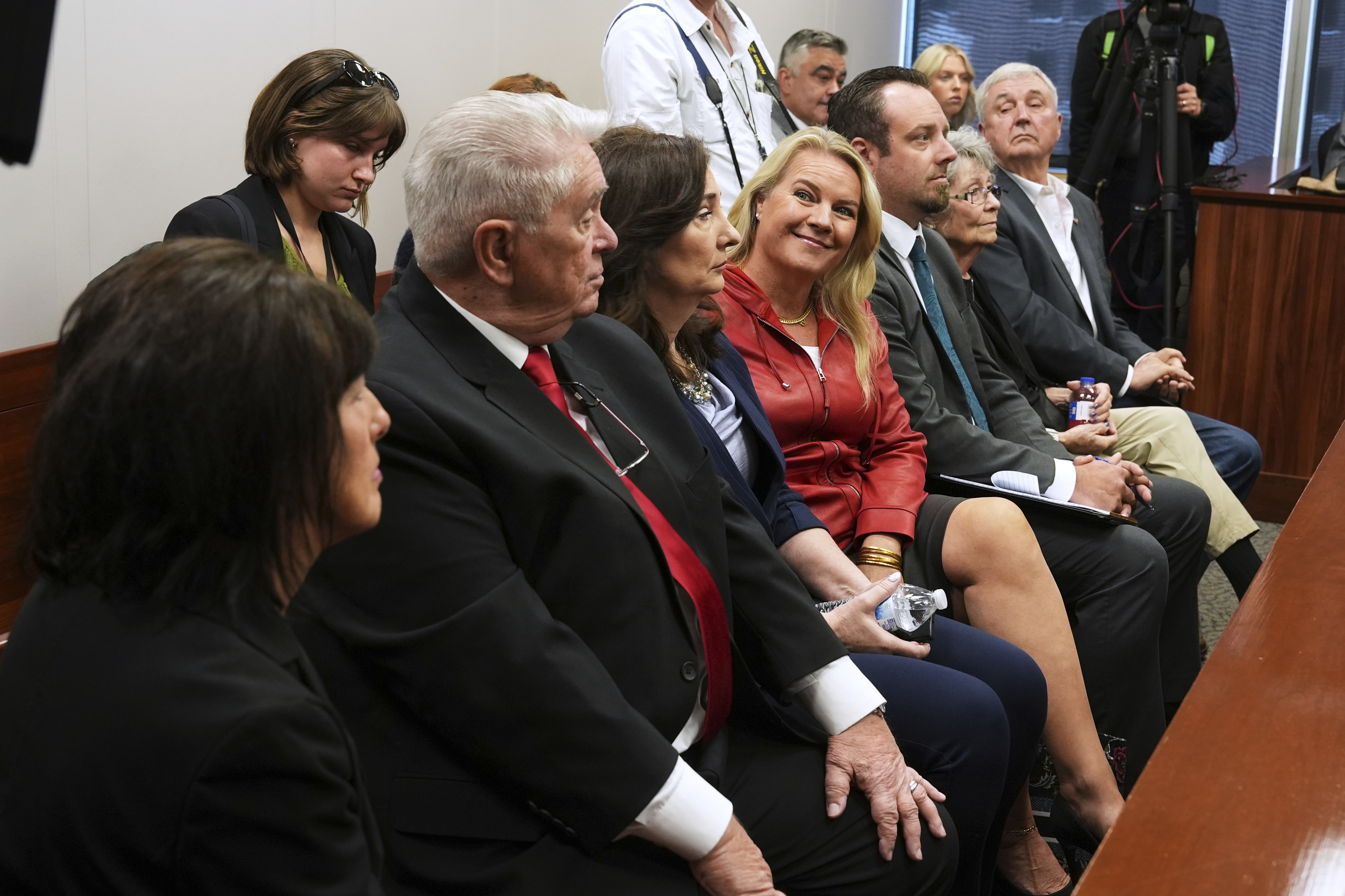 Marian Sheridan, from left, Clifford Frost, Amy Facchinello, Meshawn Maddock, an unidentified attorney, Rose Rook and Hank Choate appear during a district court hearing where a Michigan judge dismissed the criminal cases against 15 people accused of acting falsely as electors for President Donald Trump in the 2020 election Tuesday, Sept. 9, 2025 in Lansing, Mich. (Paul Sancya - AP)