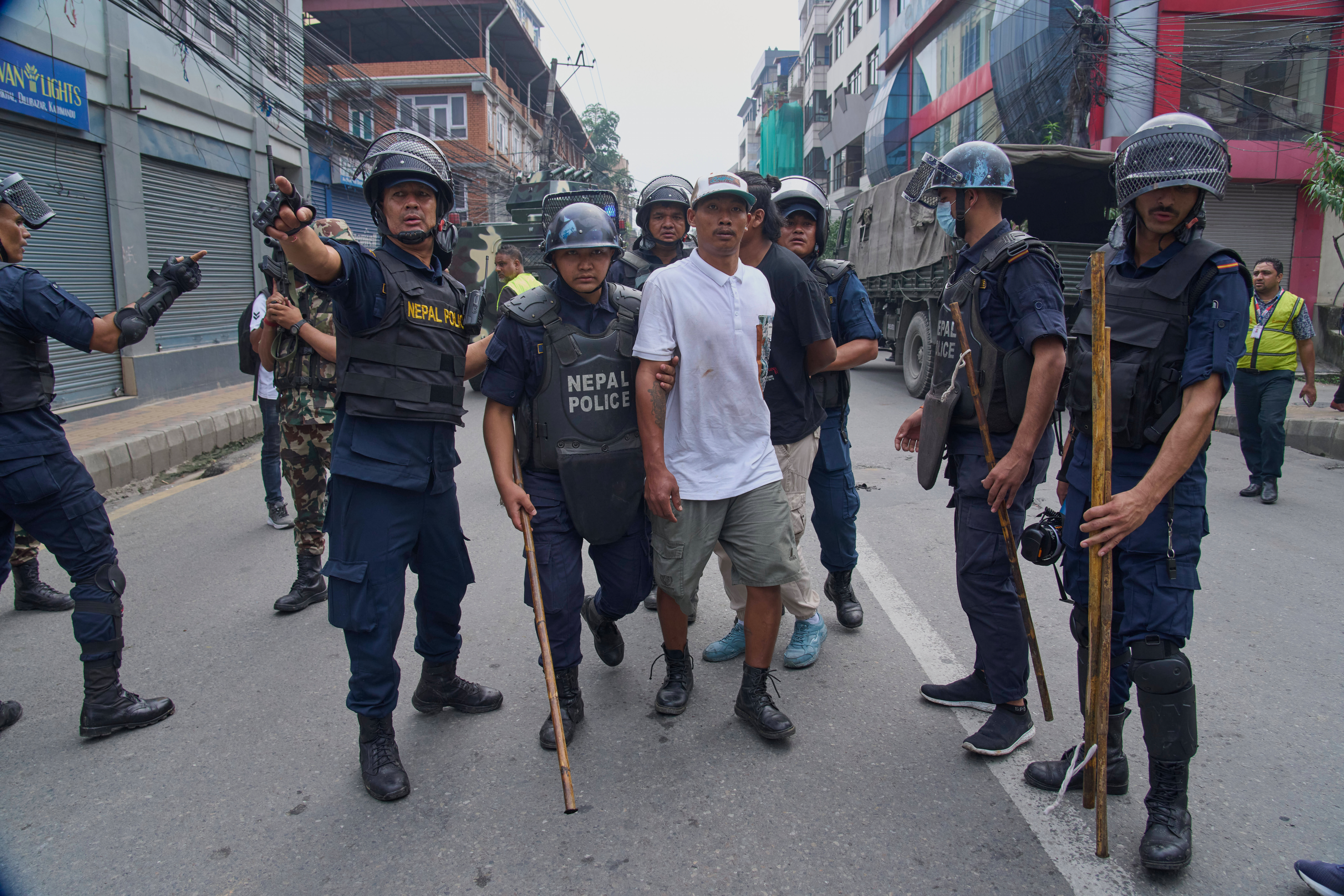 Policemen arrest a prisoner who escaped from Dilli Bazaar jail in Kathmandu, Nepal, Wednesday, Sept. 10, 2025. (Niranjan Shrestha - AP)