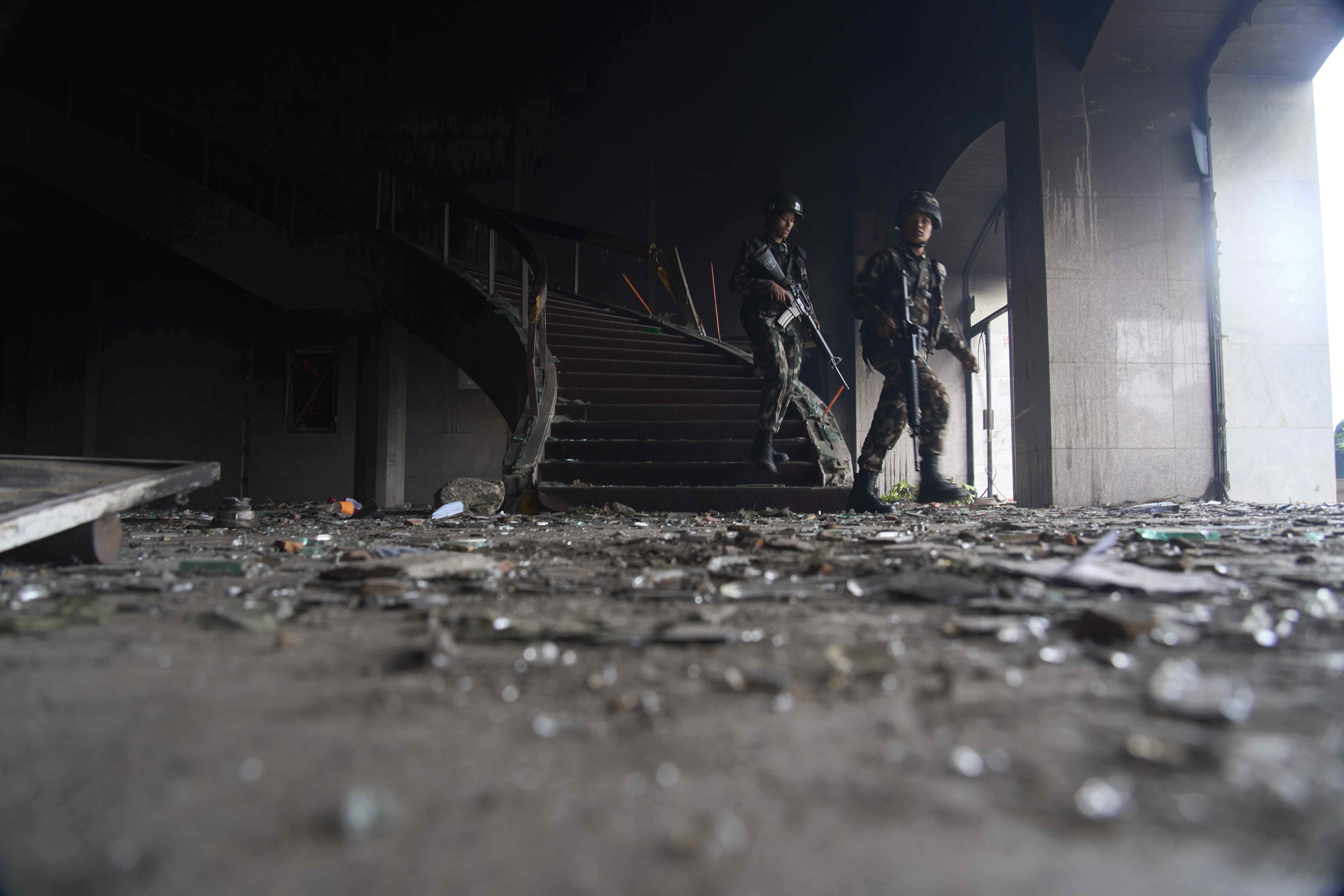 Nepalese army personnel clear civilians inside the burnt parliament building in Kathmandu, Nepal, Wednesday, Sept. 10, 2025. (Niranjan Shrestha - AP)