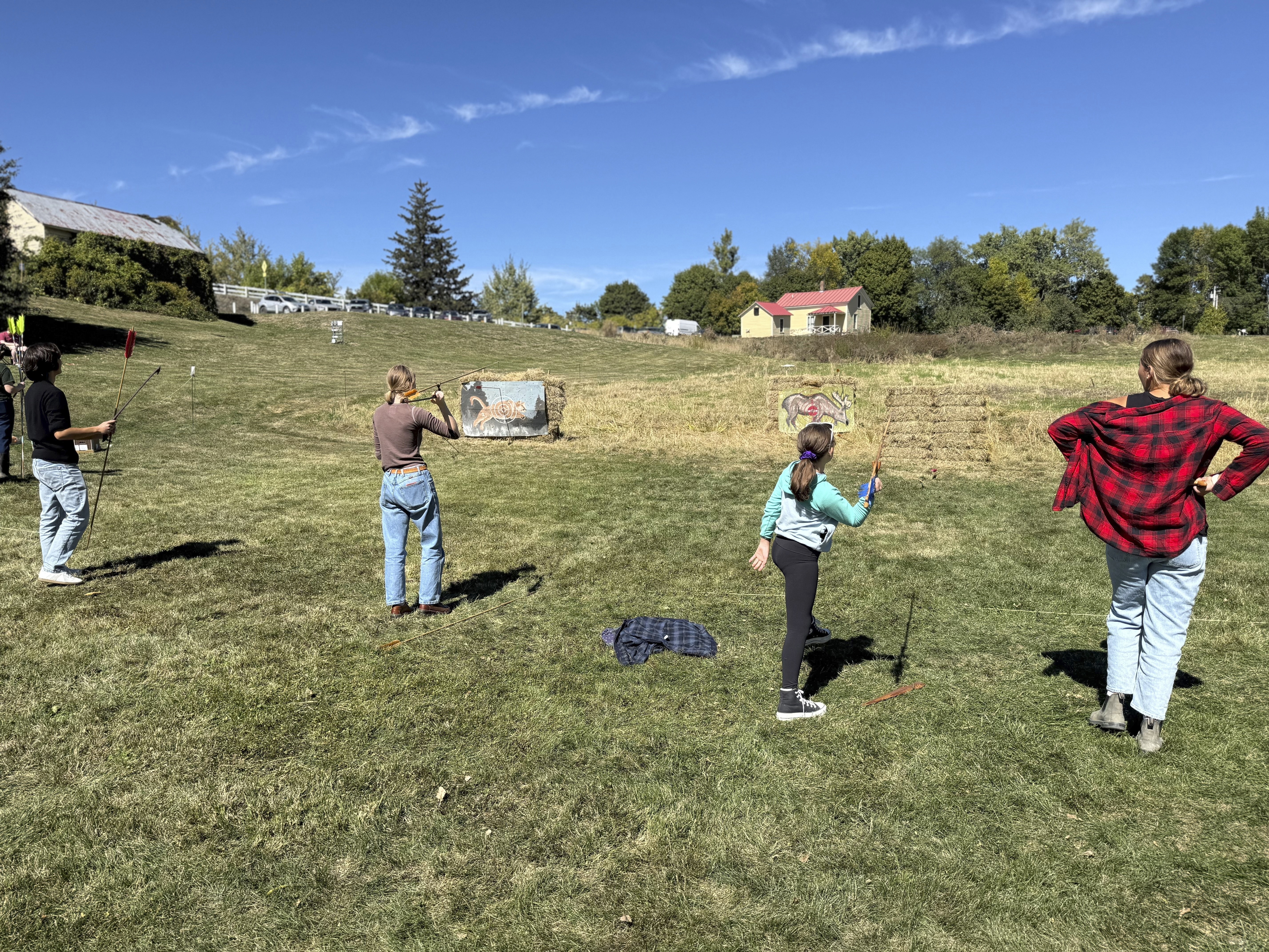 Competitors practice throwing an atlatl at painted animal targets during the Northeastern Atlatl Championship in Addison, Vt. on Saturday, Sept. 20, 2025. (Amanda Swinhart - AP)