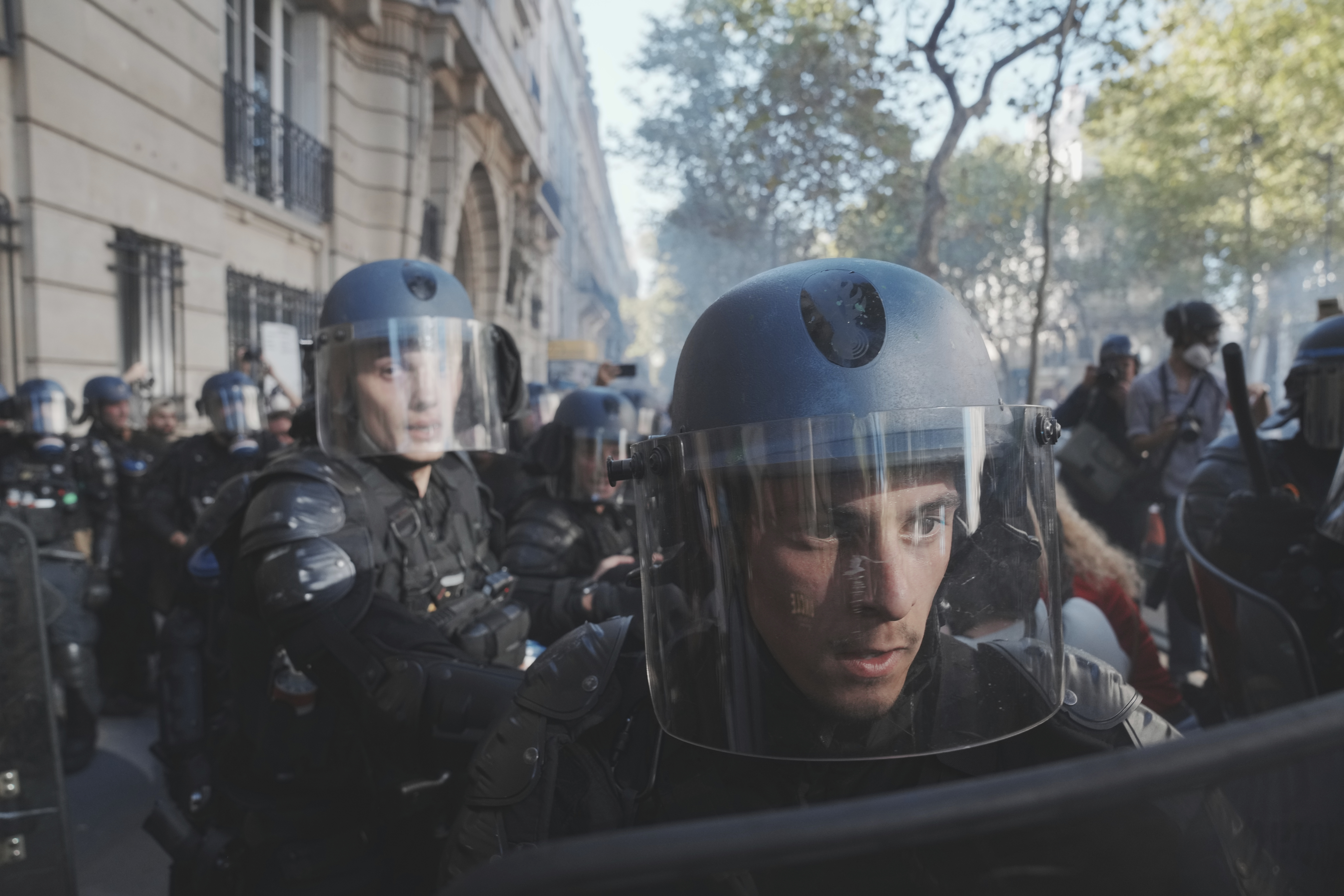Police officers face protesters during a demonstration called by major trade unions to oppose budget cuts, in Paris, France, Thursday, Sept. 18, 2025. (Thibault Camus - AP)