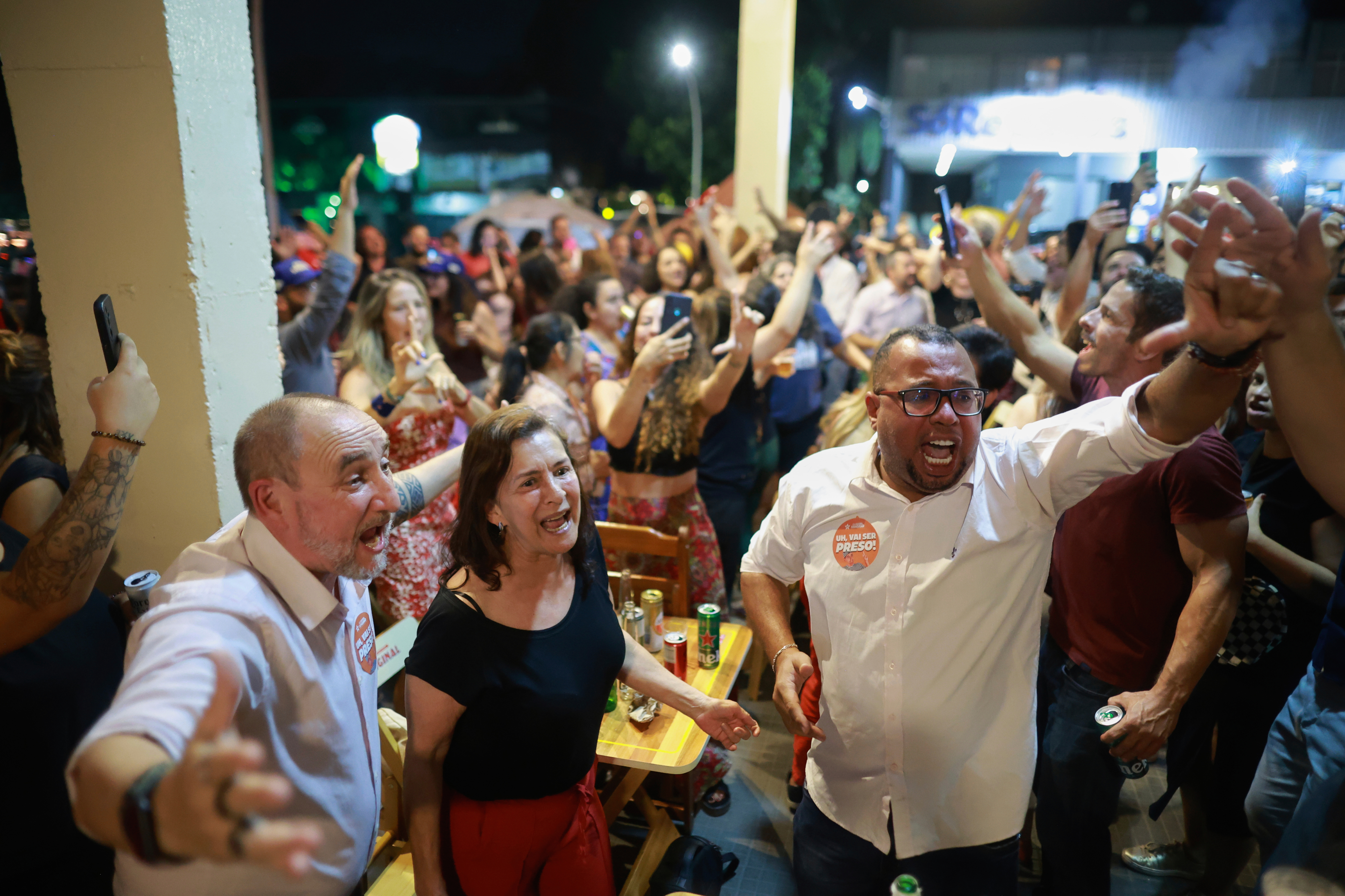 Opponents of former President Jair Bolsonaro celebrate at a bar after the Supreme Court sentenced him to more than 27 years in prison for attempting a coup to remain in office despite his 2022 electoral defeat, in Brasilia, Brazil, Thursday, Sept. 11, 2025. (Luis Nova - AP)