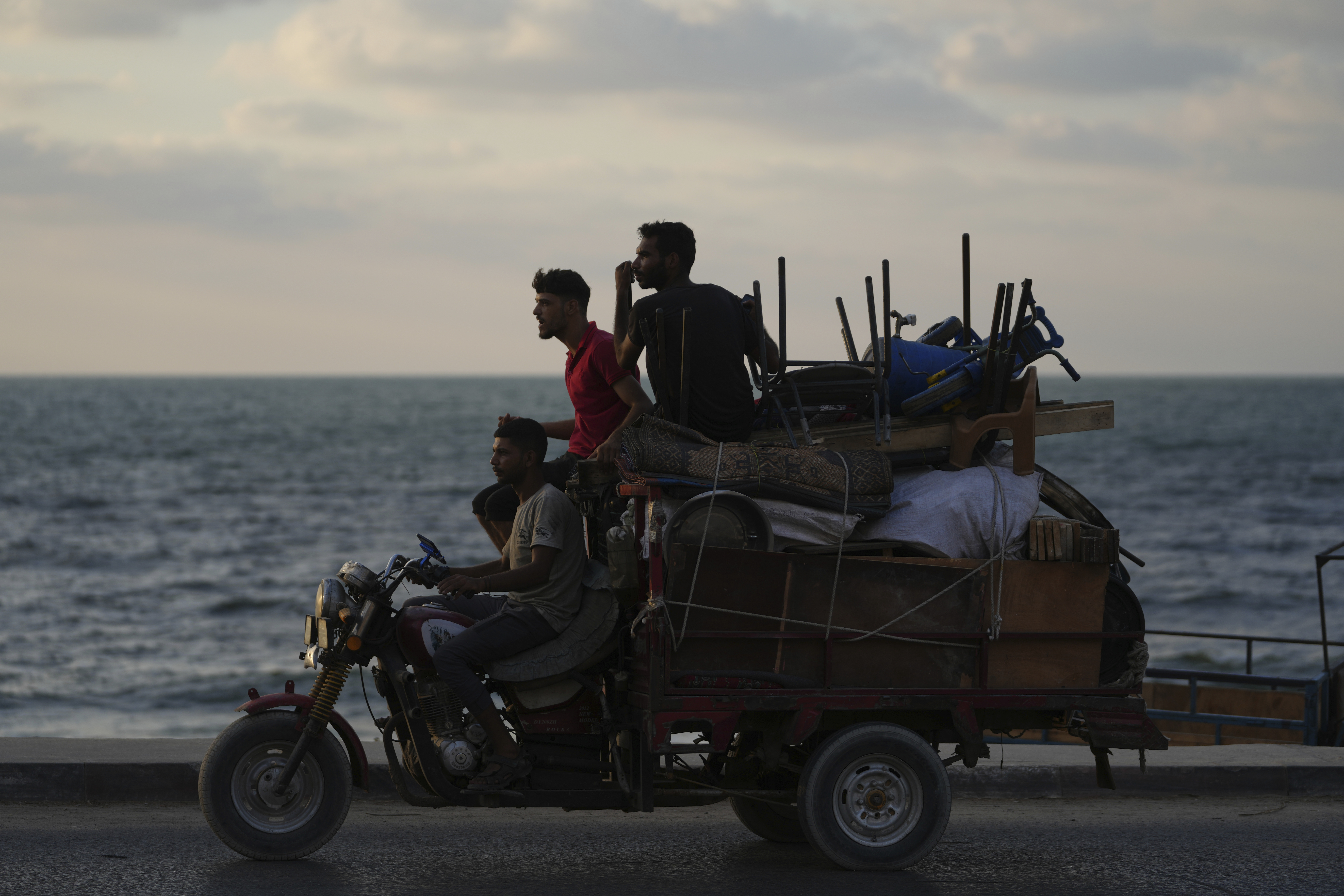 Displaced Palestinians fleeing northern Gaza carry their belongings along the coastal road toward southern Gaza, Saturday, Sept. 6, 2025. (Jehad Alshrafi - AP)