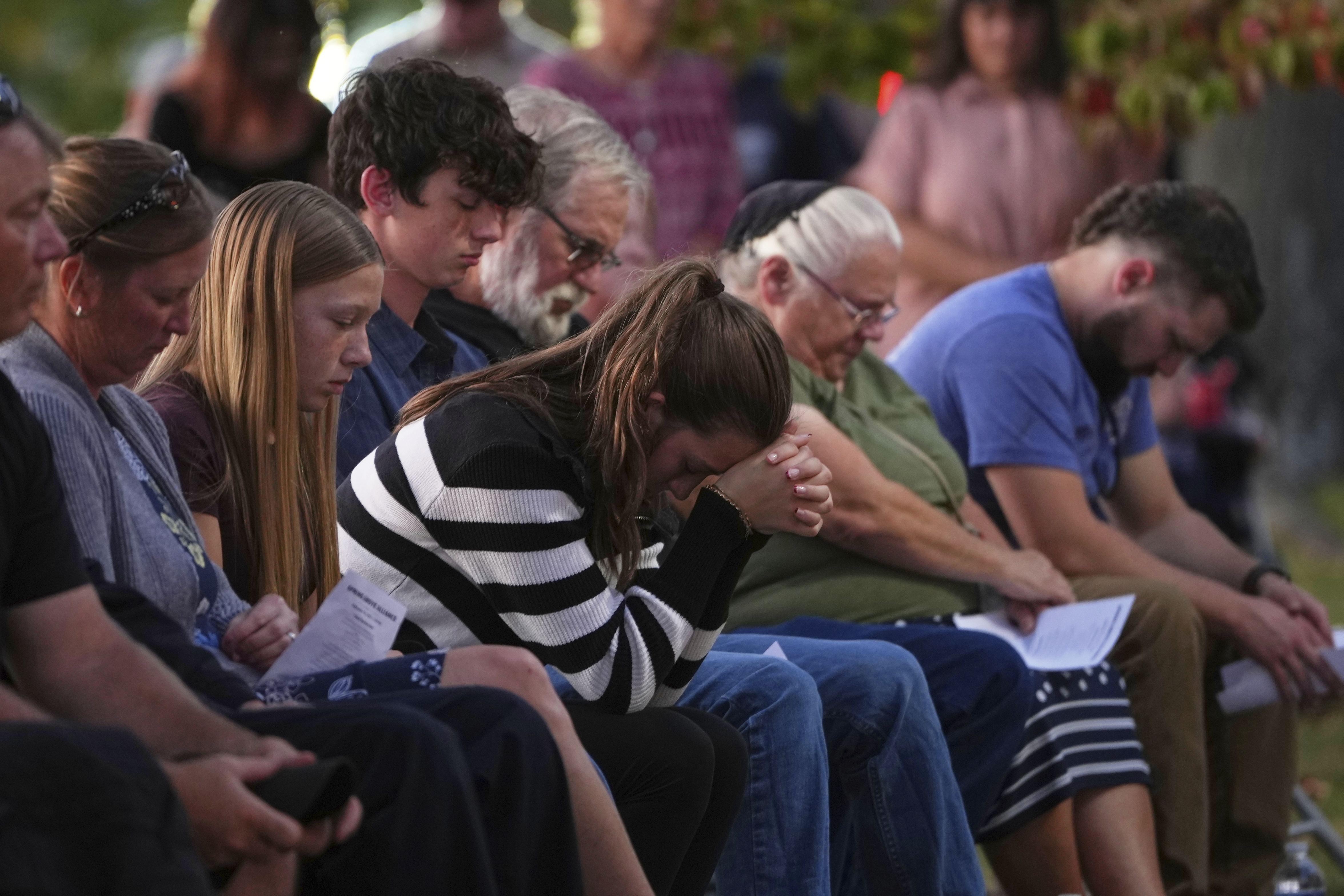 Attendees react during a vigil at Spring Grove Alliance church Thursday, Sept. 18, 2025, in Spring Grove, Pa., after multiple police officers were shot and killed. (Matt Slocum - AP)