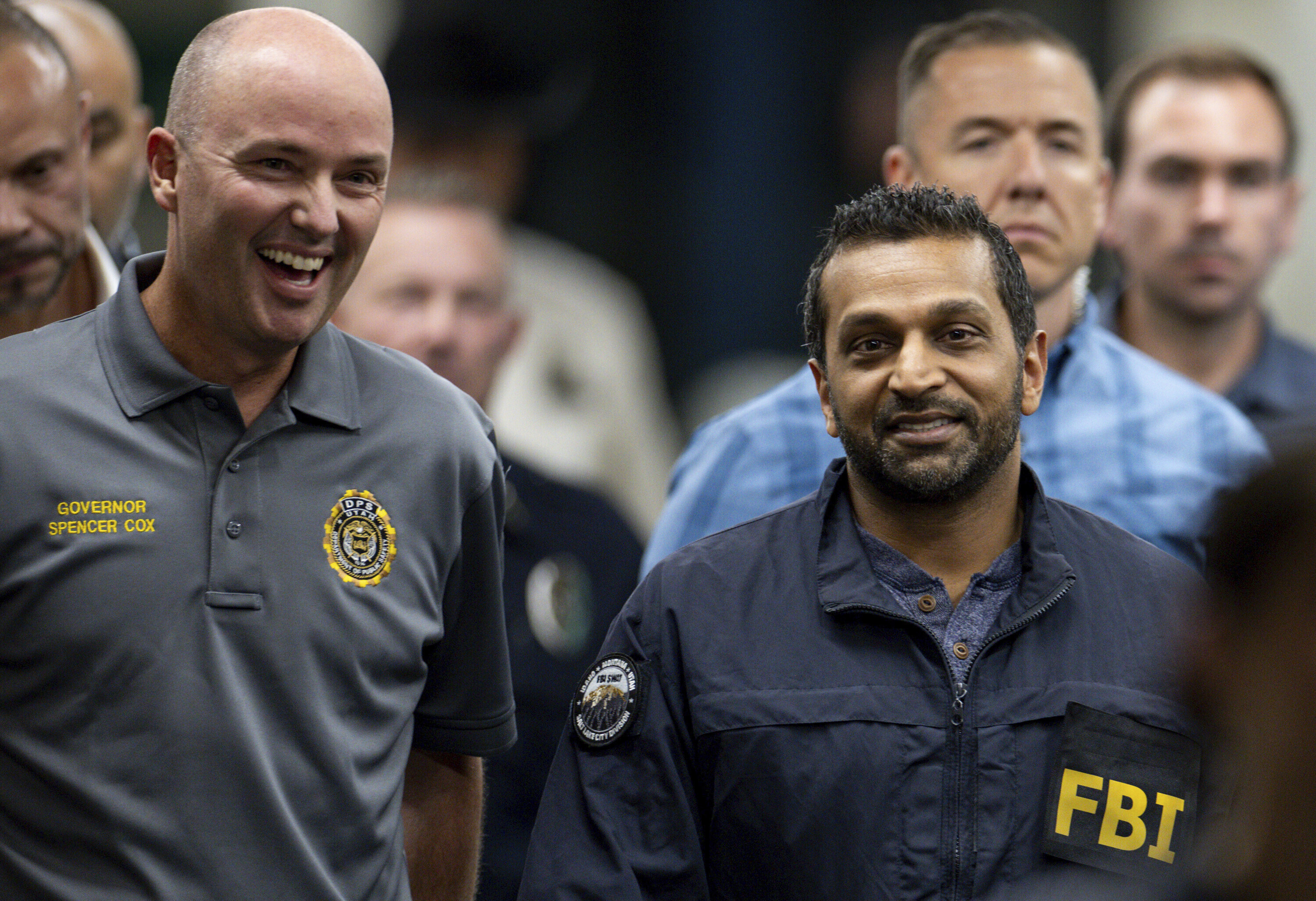 Utah Gov. Spencer Cox, left, and FBI Director Kash Patel, right, converse as they make their way to a press conference to speak to media about the shooting death of Charlie Kirk at Utah Valley University in Orem, Utah, on Thursday, Sept. 11, 2025. (Rio Giancarlo - The Deseret News)