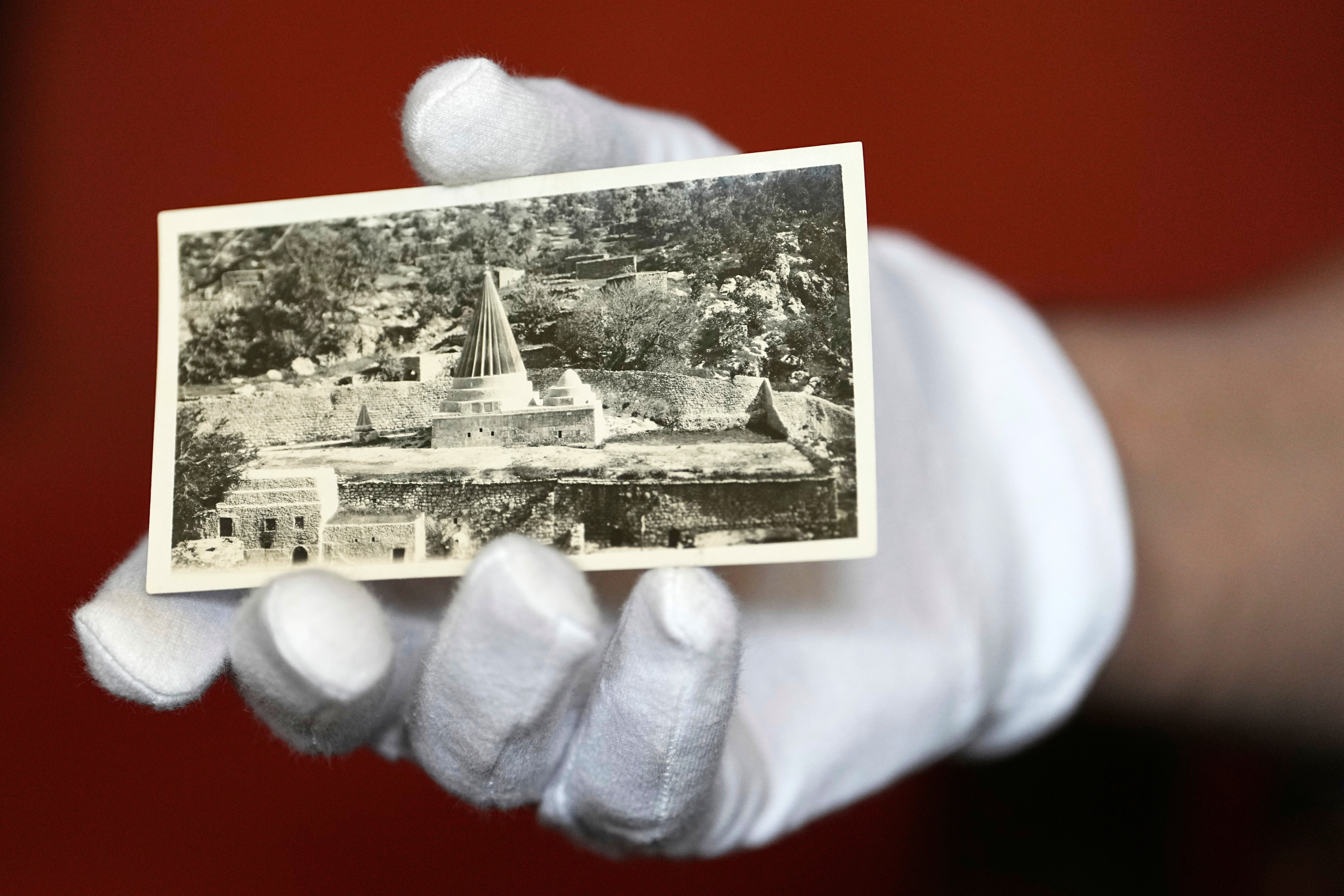 University of Pennsylvania doctoral student Marc Marin Webb displays an image from a collection of photos of the Yazidi people in their northern Iraq homeland in the 1930s, at the Penn Museum Archives in Philadelphia, Aug. 27, 2025. (Matt Rourke - AP)