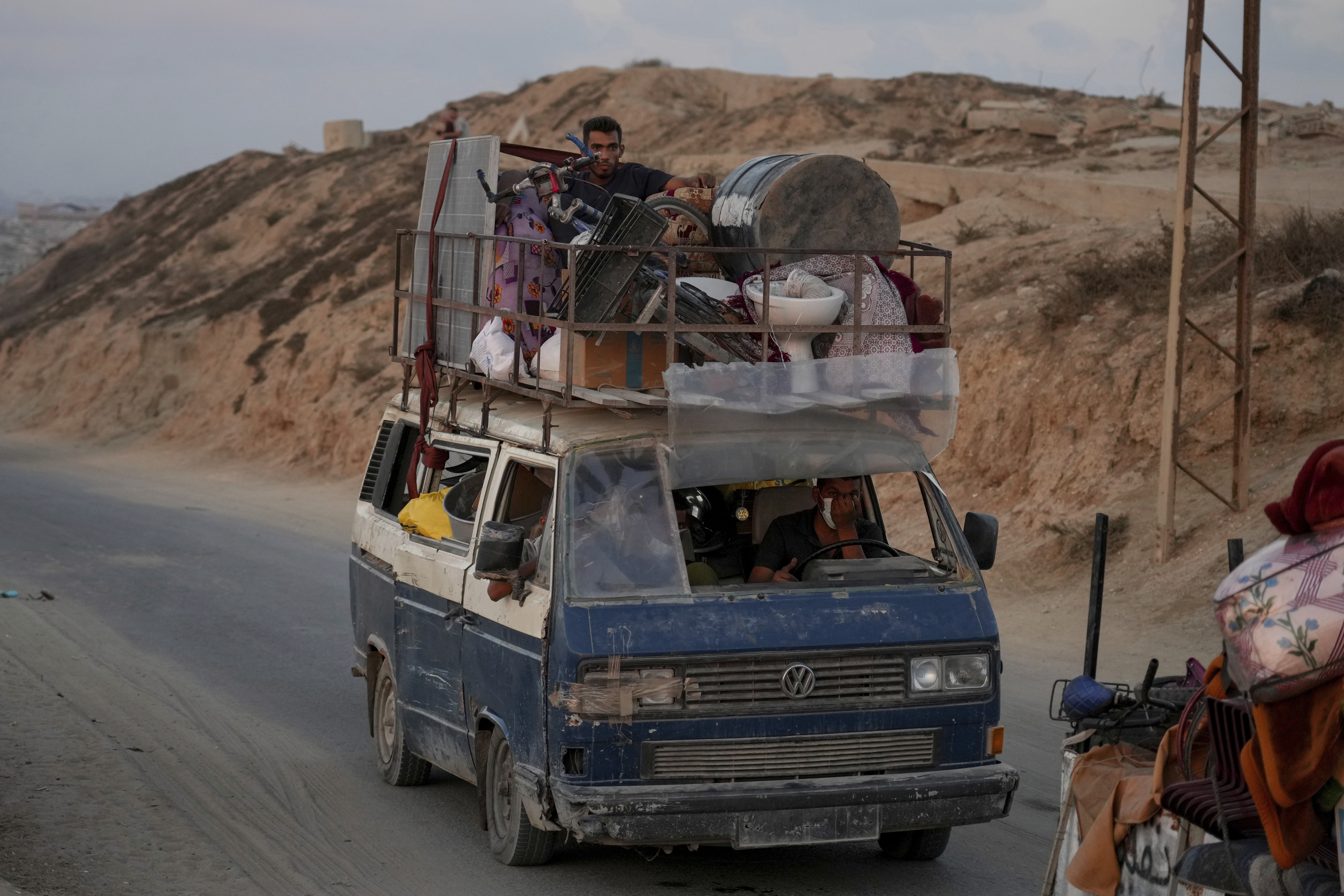 Displaced Palestinians fleeing northern Gaza carry their belongings along the coastal road toward southern Gaza ,Sunday, Sept. 7, 2025. (Jehad Alshrafi - AP)