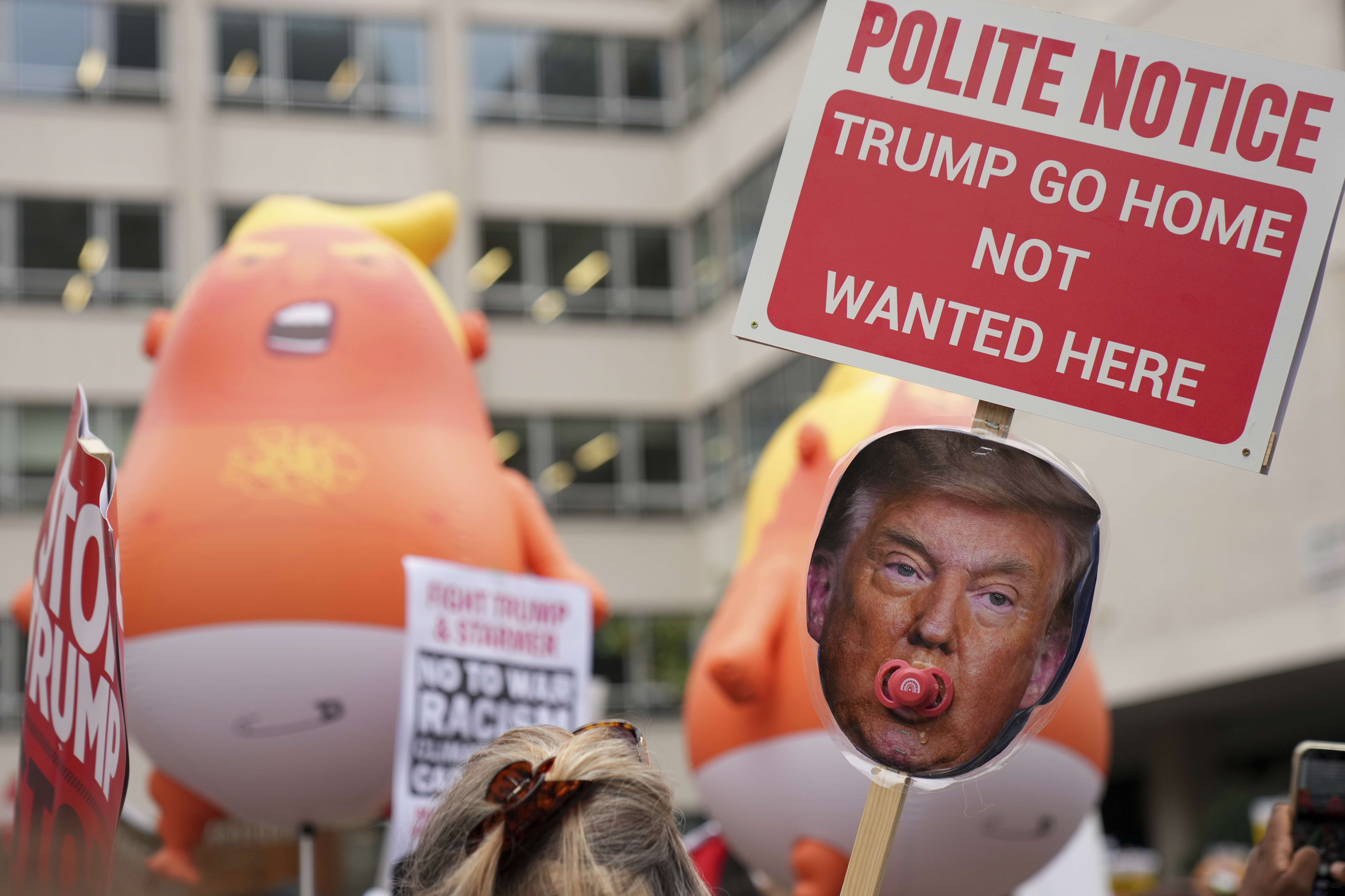 People show placards at a protest of the Stop Trump Coalition group against President Donald Trump's state visit in London, Wednesday, Sept. 17, 2025. (Joanna Chan - AP)