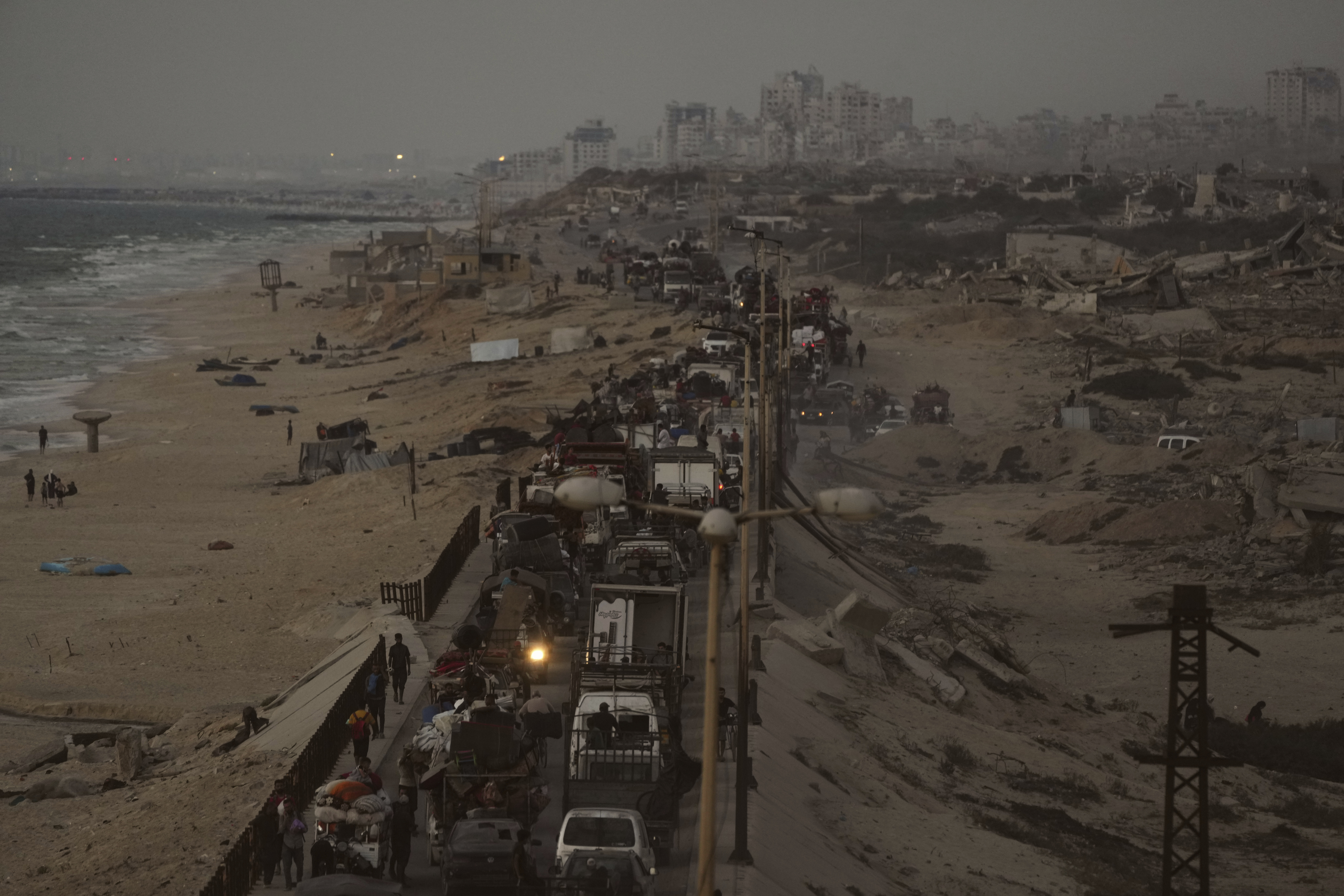 Displaced Palestinians fleeing northern Gaza carry their belongings along the coastal road toward southern Gaza, Thursday, Sept. 11, 2025, after the Israeli army issued evacuation orders from Gaza City. (Jehad Alshrafi - AP)
