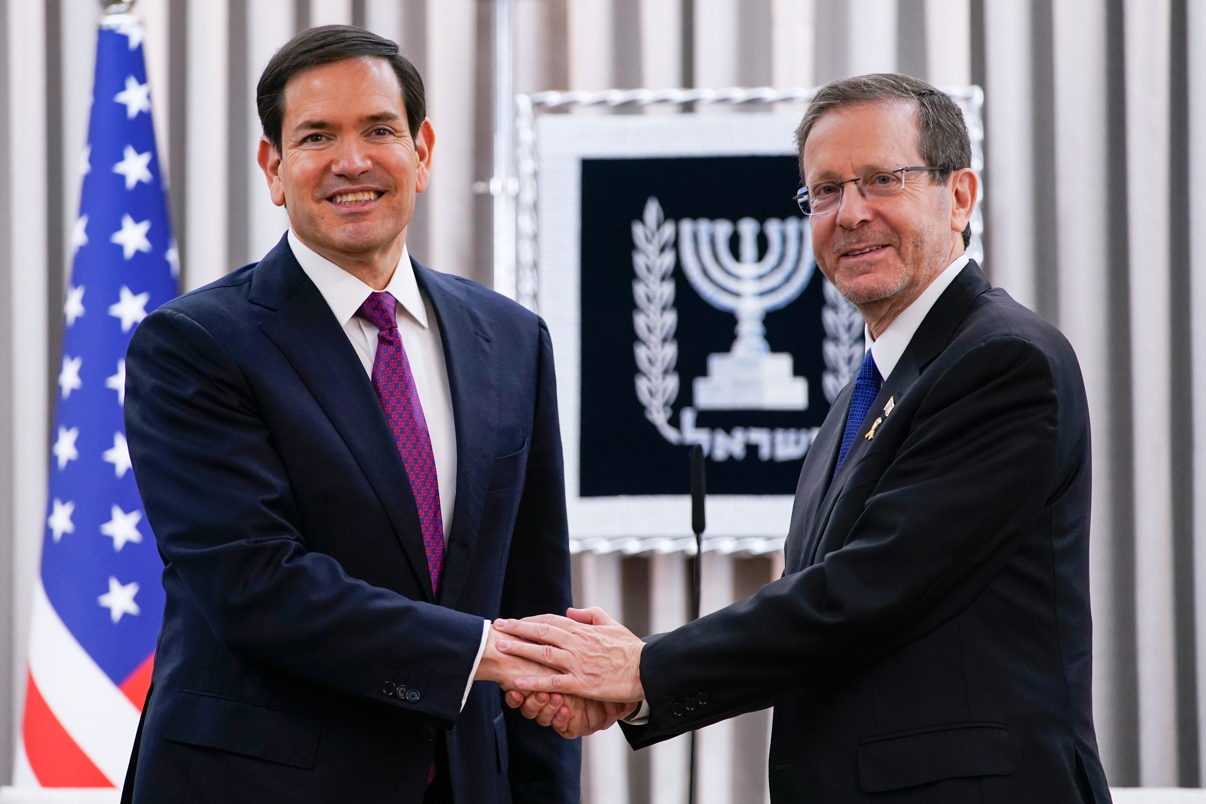 U.S. Secretary of State Marco Rubio and Israeli President Isaac Herzog shake hands ahead of a meeting at the Beit Hanassi presidential residence, during Rubio's visit, in Jerusalem, Monday, Sept. 15, 2025. (Nathan Howard - Pool Reuters)
