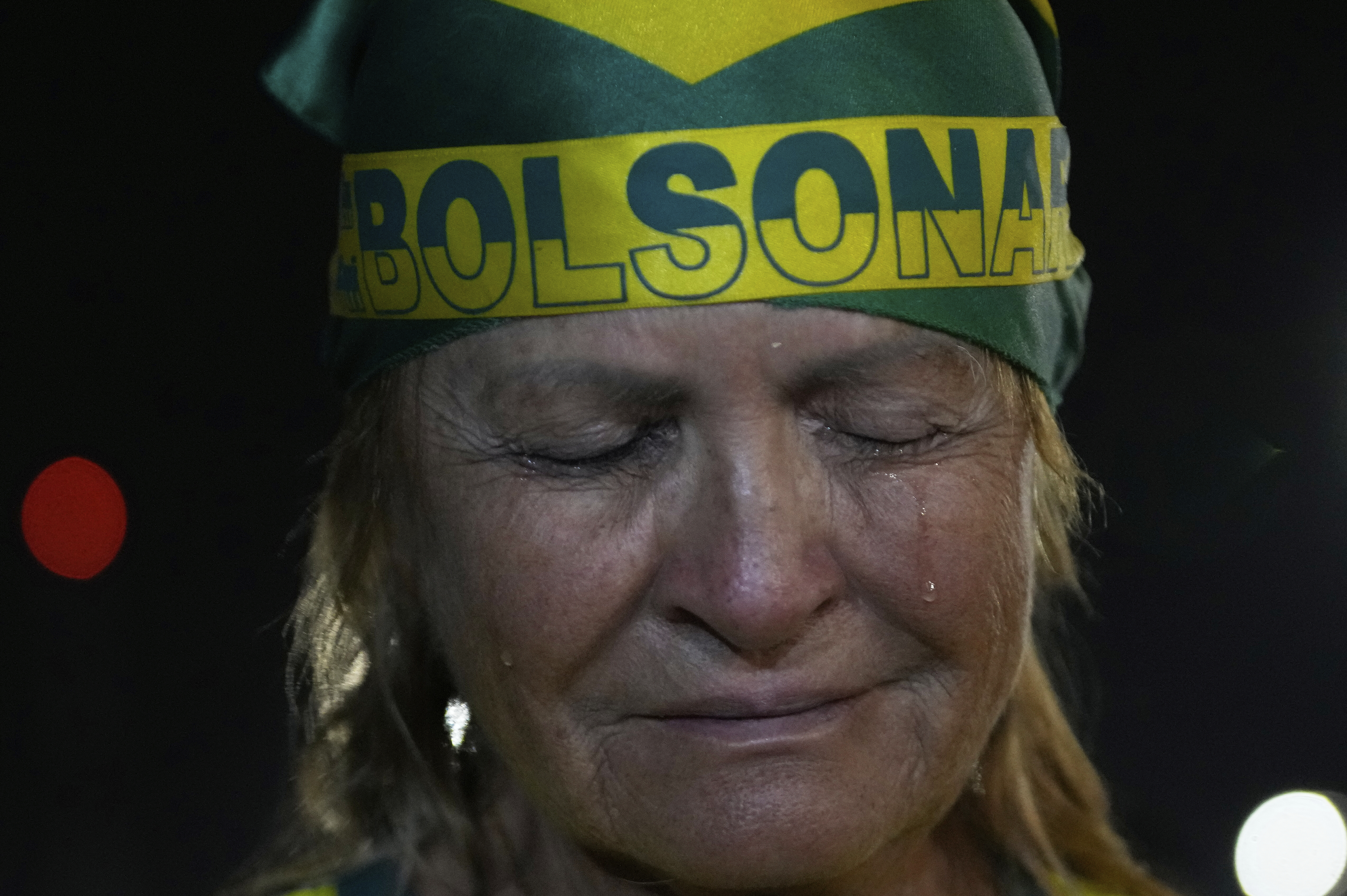 A supporter of former President Jair Bolsonaro cries during a vigil in his support near his home where he is under house arrest in Brasilia, Brazil, Thursday, Sept. 11, 2025. (Eraldo Peres - AP)