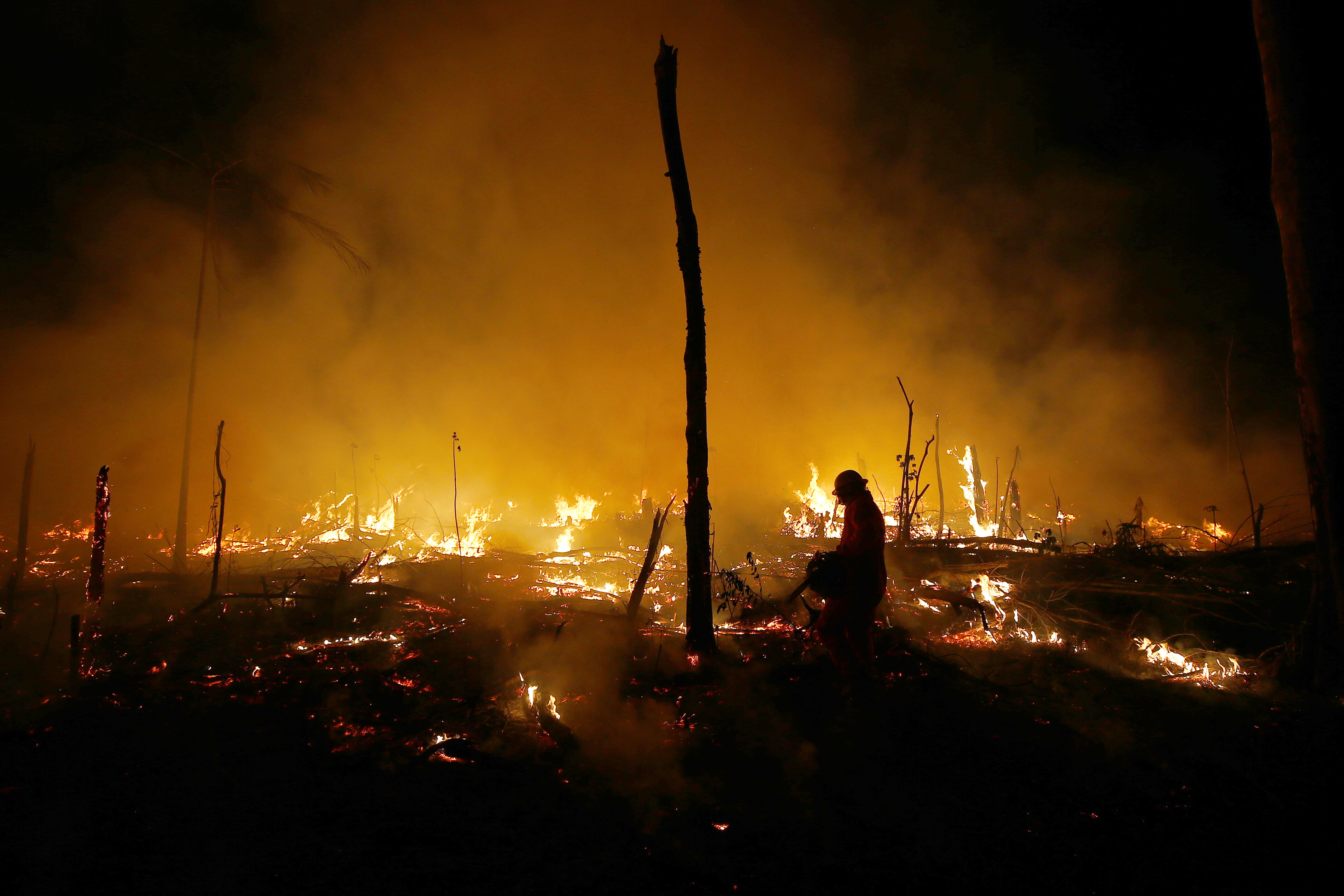 FILE - Firefighters work to put out a blaze in the Amazon forest during a drought and high temperatures in the rural municipality of Careiro Castanho, Amazonas state, Brazil, Oct. 21, 2023. (Edmar Barros - AP)