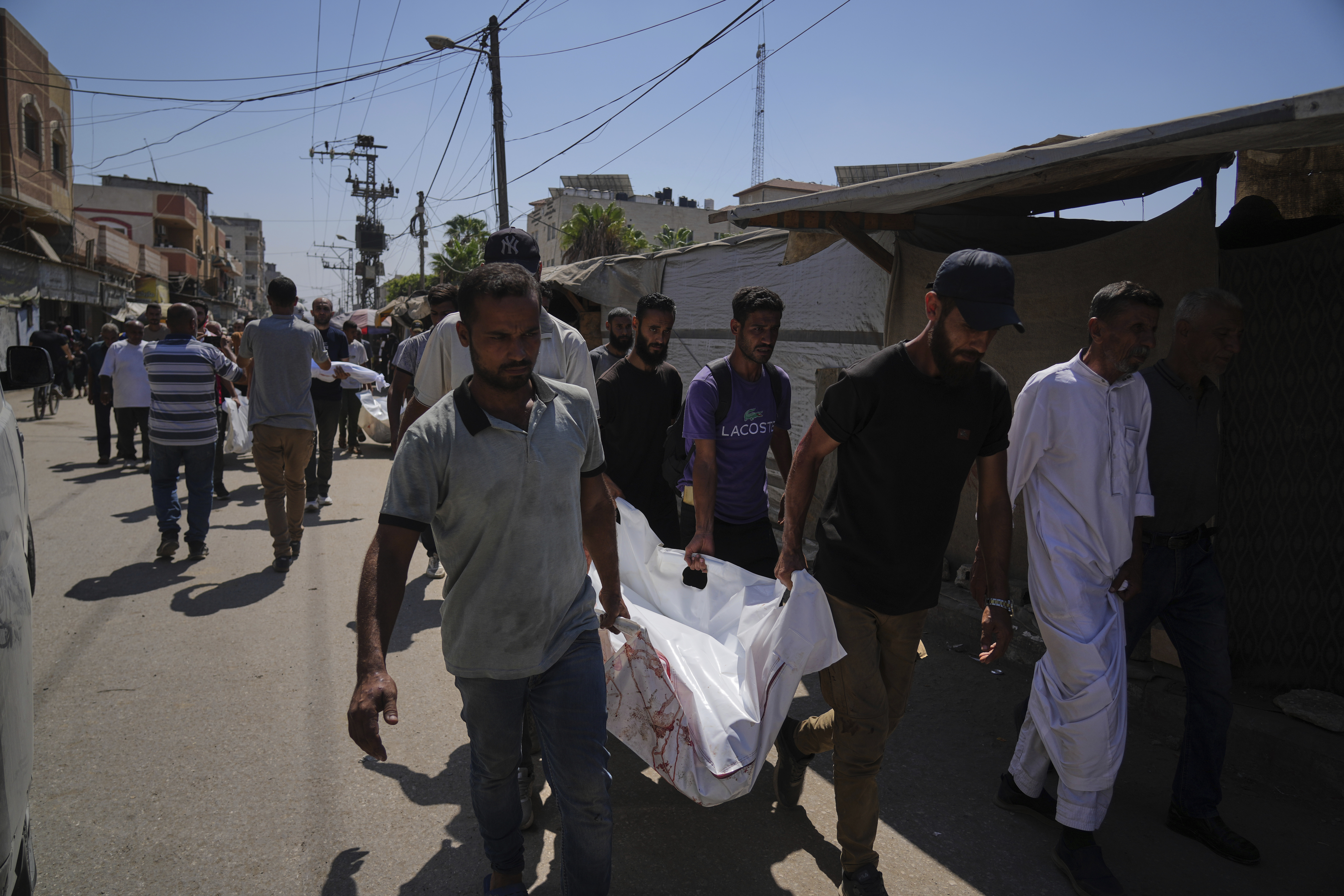 Palestinians carry the body of Aliya Abu Ouda, 37, killed in an Israeli airstrike on the Gaza Strip, in Deir al-Balah, Sunday, Sept. 14, 2025. (Abdel Kareem Hana - AP)