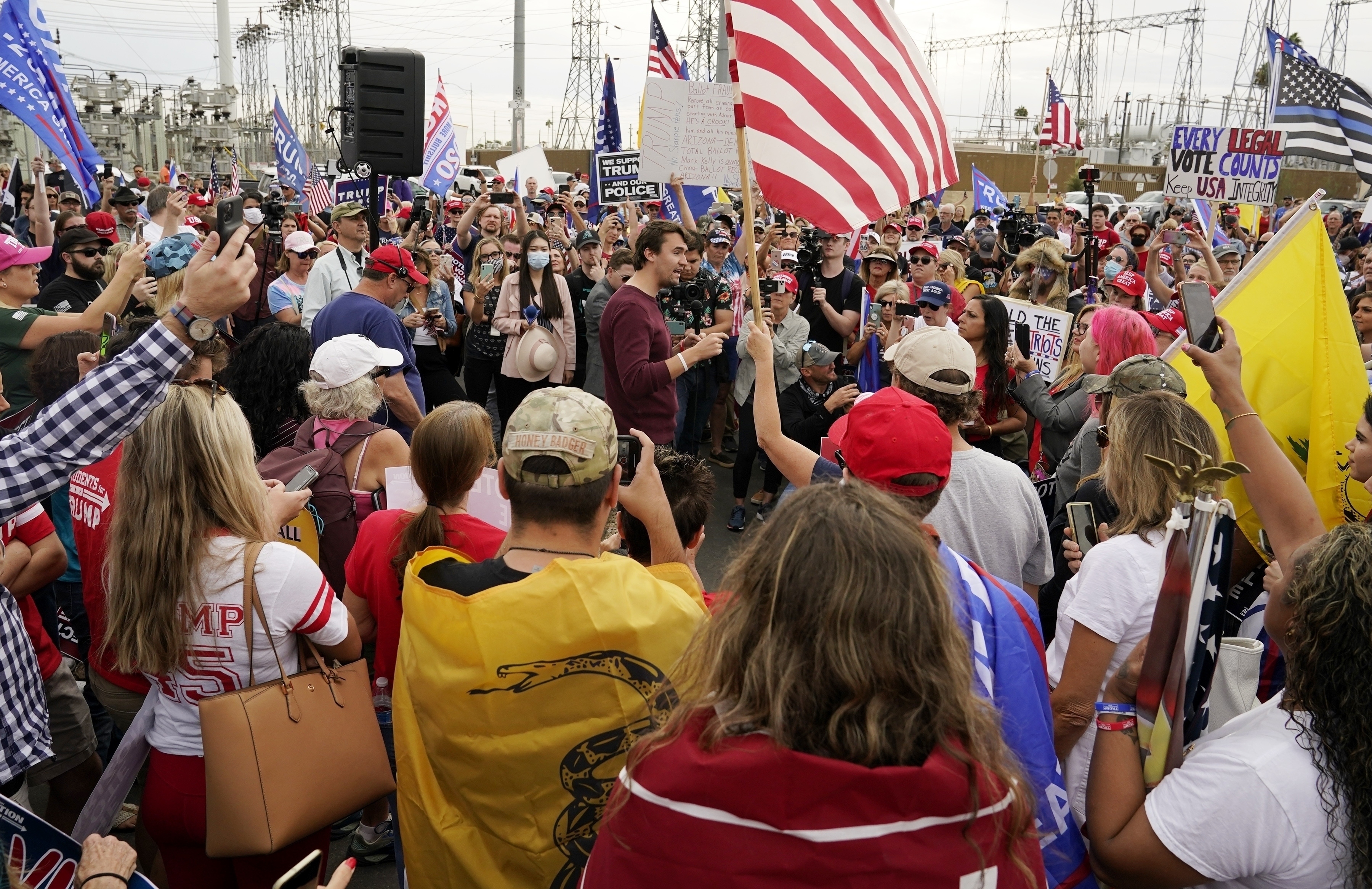 FILE - Charlie Kirk, center, conservative activist and founder of Turning Point USA, speaks to supporters of President Donald Trump at a rally, Nov. 6, 2020, in Phoenix. (Ross D. Franklin - AP)