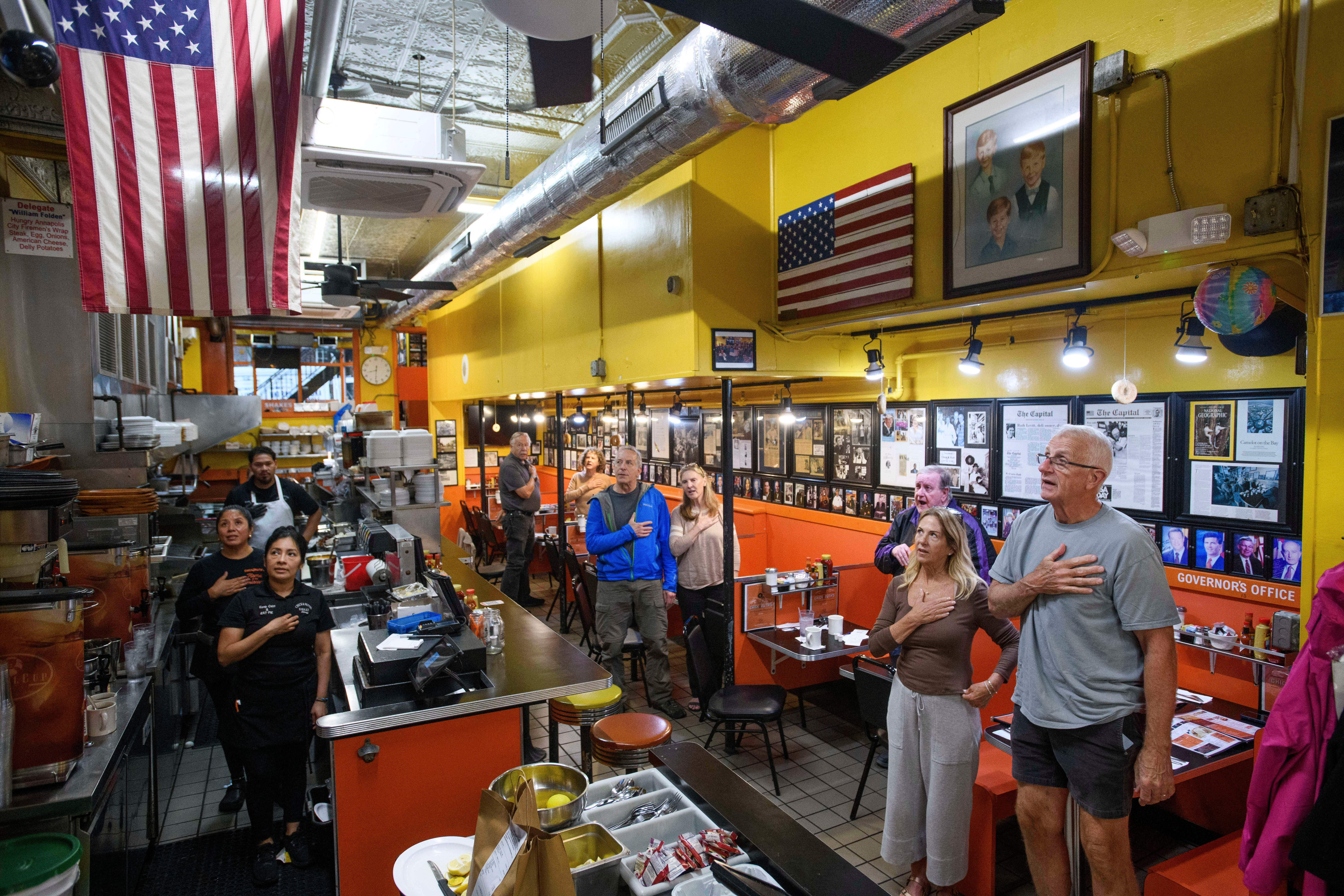 On the 24th anniversary of the 9/11 terrorist attacks, customers and employees stand for the daily Pledge of Allegiance at Chick & Ruth's Delly, where has been recited in the morning, seven days a week since 1989, in Annapolis, Md., Thursday, Sept. 11, 2025. (Rod Lamkey - FR172078)