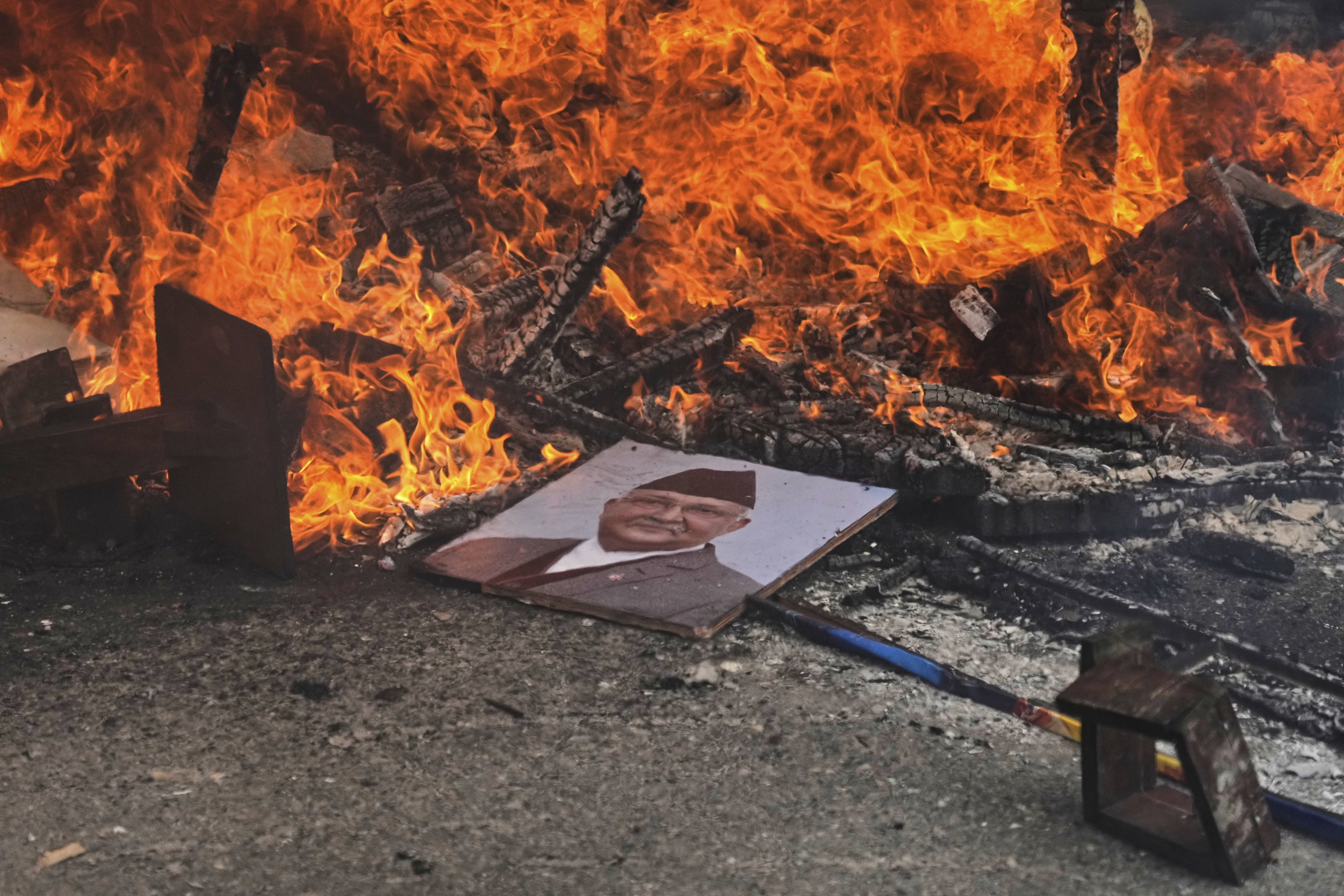 Protesters burn a photograph of Nepal's Prime Minister Khadga Prasad Oli at the Singha Durbar, the seat of Nepal's government's various ministries and offices during a protest against social media ban and corruption in Kathmandu, Nepal, Tuesday, Sept. 9, 2025. (Niranjan Shrestha - AP)
