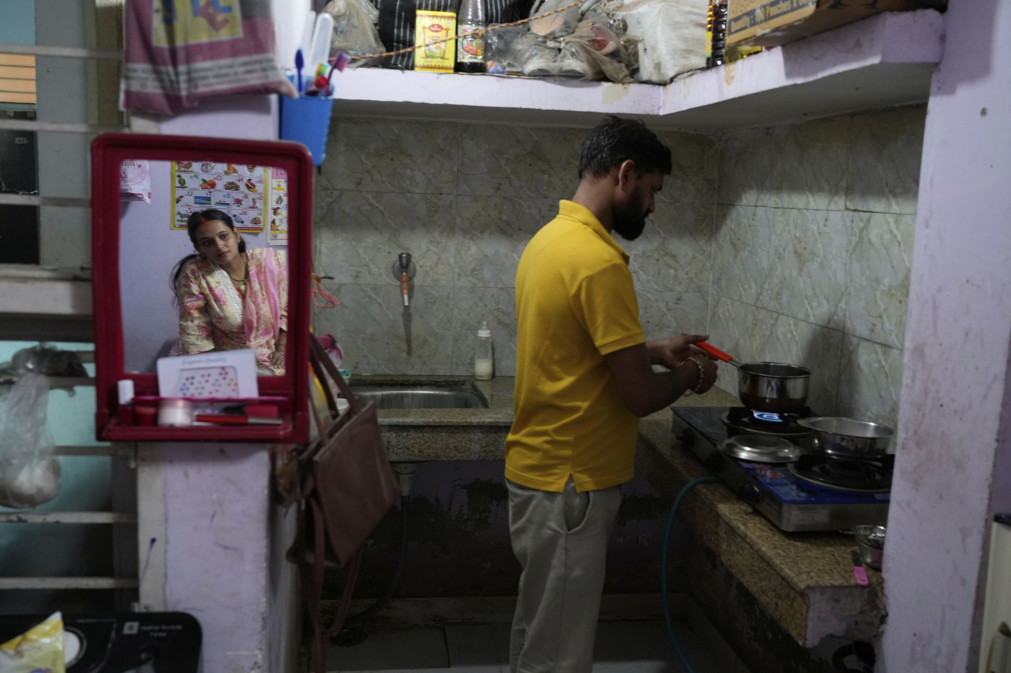 Rajkumar Varma, trained in Care Companion Program (CCP), makes tea for his pregnant wife Anju Varma at home in Gurugram, a satellite city of New Delhi, India, on Aug. 8, 2025. (Manish Swarup - AP)
