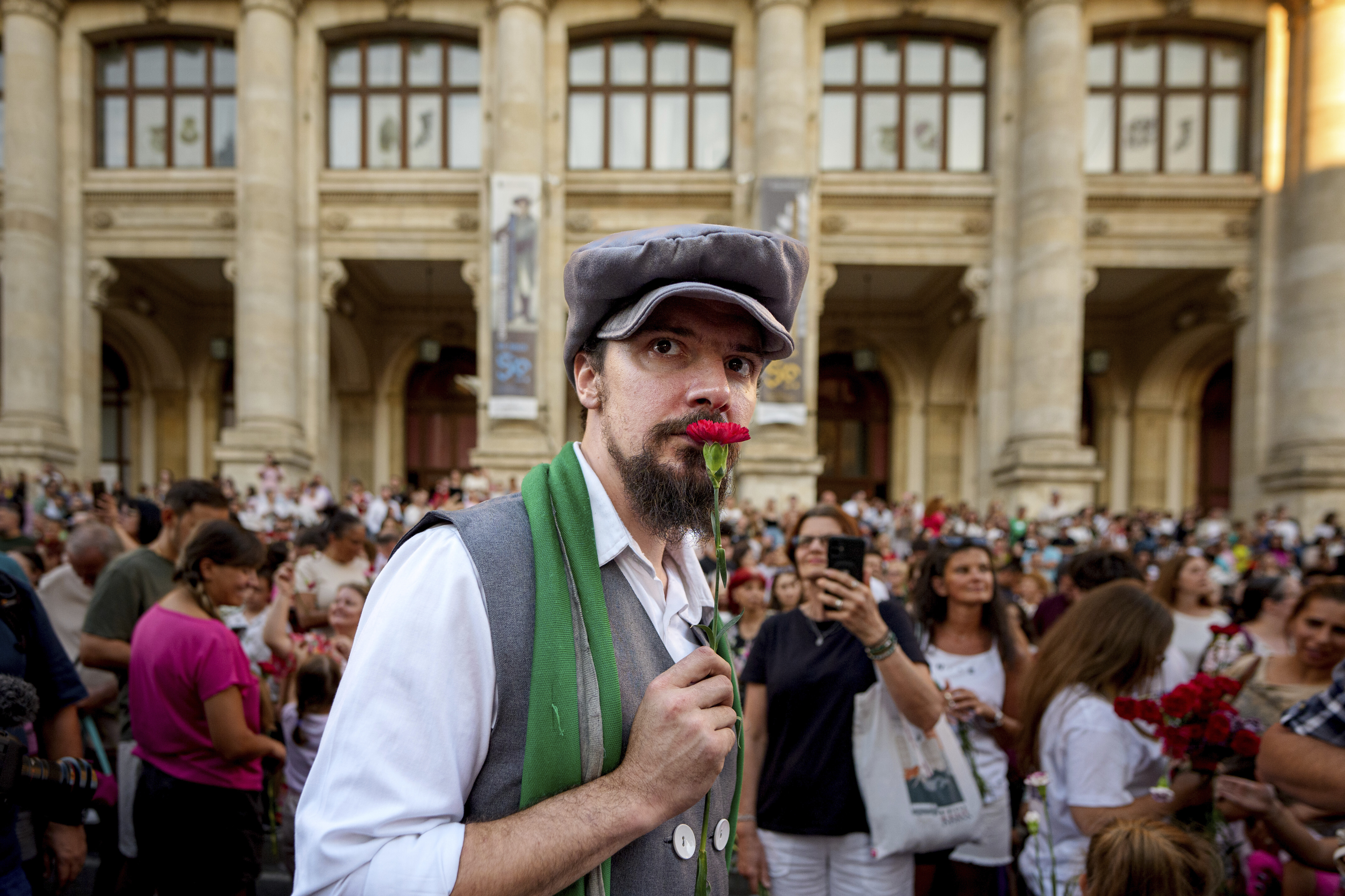 A man wearing vintage styled outfit holds a carnation during an event marking the day when the Romanian capital was first mentioned in historical records, 566 years ago, in Bucharest, Romania, Saturday, Sept. 20, 2025. (Andreea Alexandru - AP)