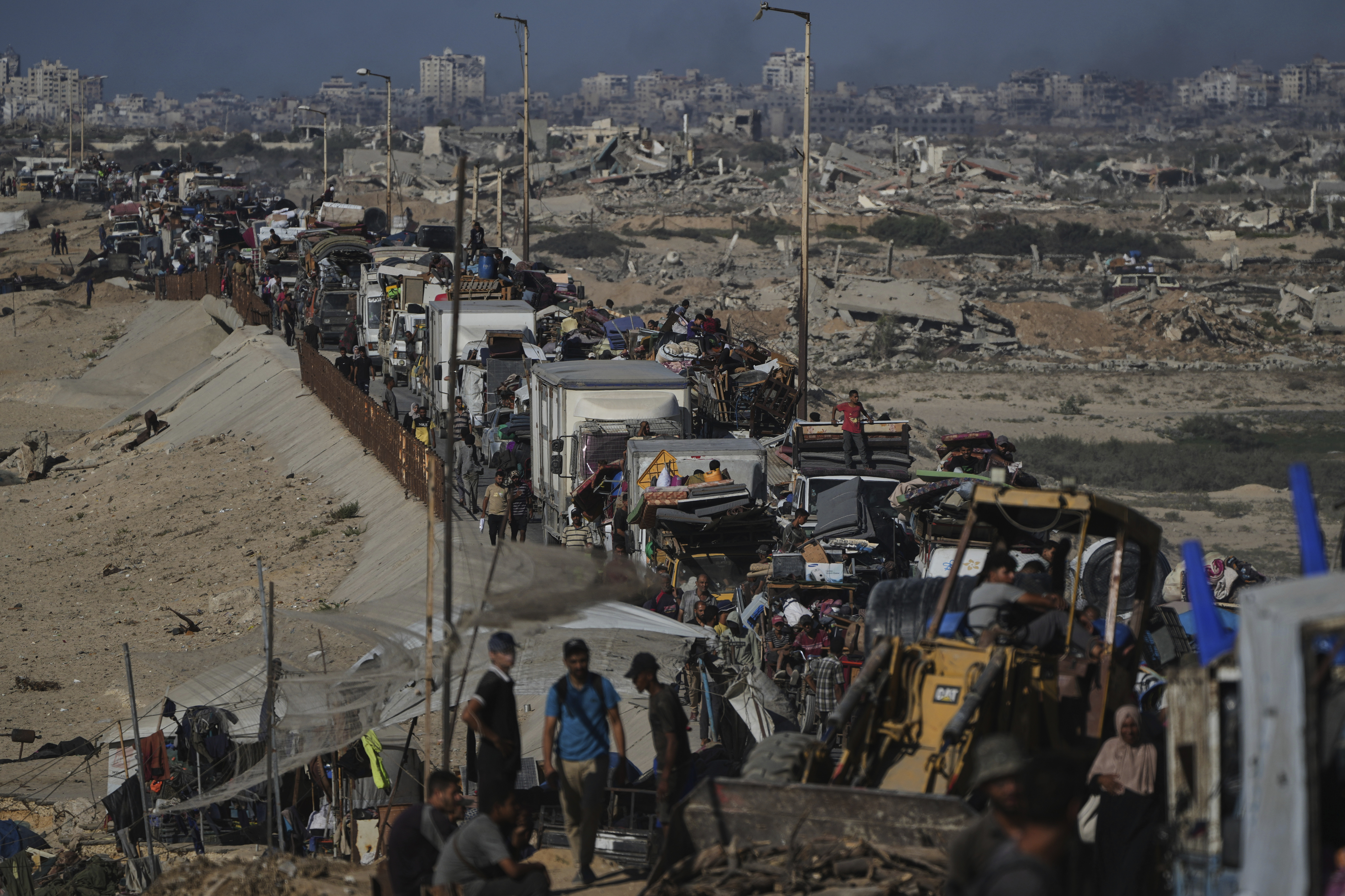 Displaced Palestinians fleeing northern Gaza carry their belongings along the coastal road toward southern Gaza, Wednesday, Sept. 10, 2025, after the Israeli army issued evacuation orders from Gaza City. (Abdel Kareem Hana - AP)