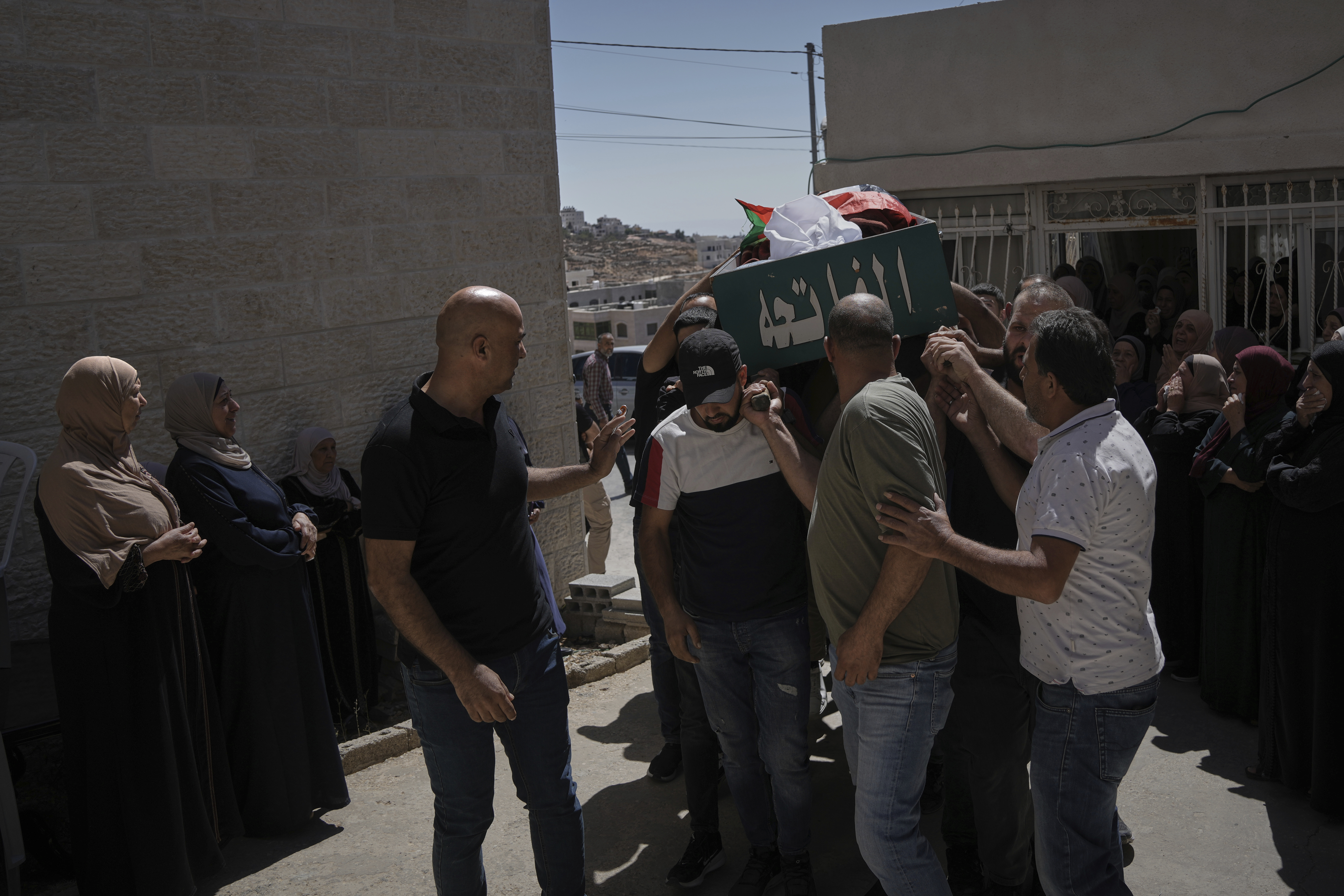 Mourners carry the body of Mohammad Alawi, 21, who according to Palestinian health officials died after being shot by settlers, during his funeral in the West Bank town of Deir Jarir, Sunday, Sept. 14, 2025. (Mahmoud Illean - AP)