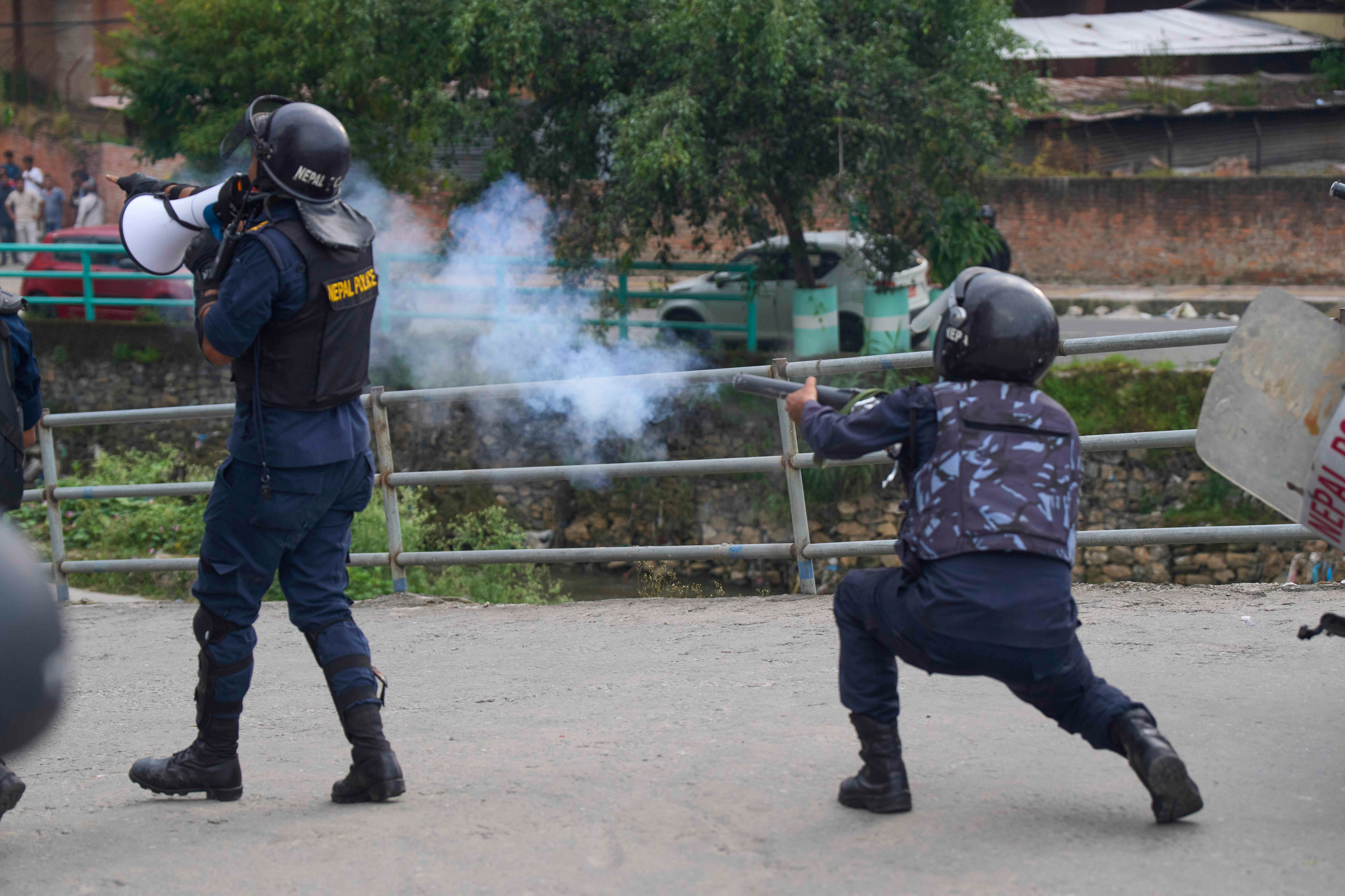 A policemen fires a tear gas shell towards protesters during clashes outside the parliament building in Kathmandu, Nepal, Monday, Sept. 8, 2025. (Niranjan Shrestha - AP)