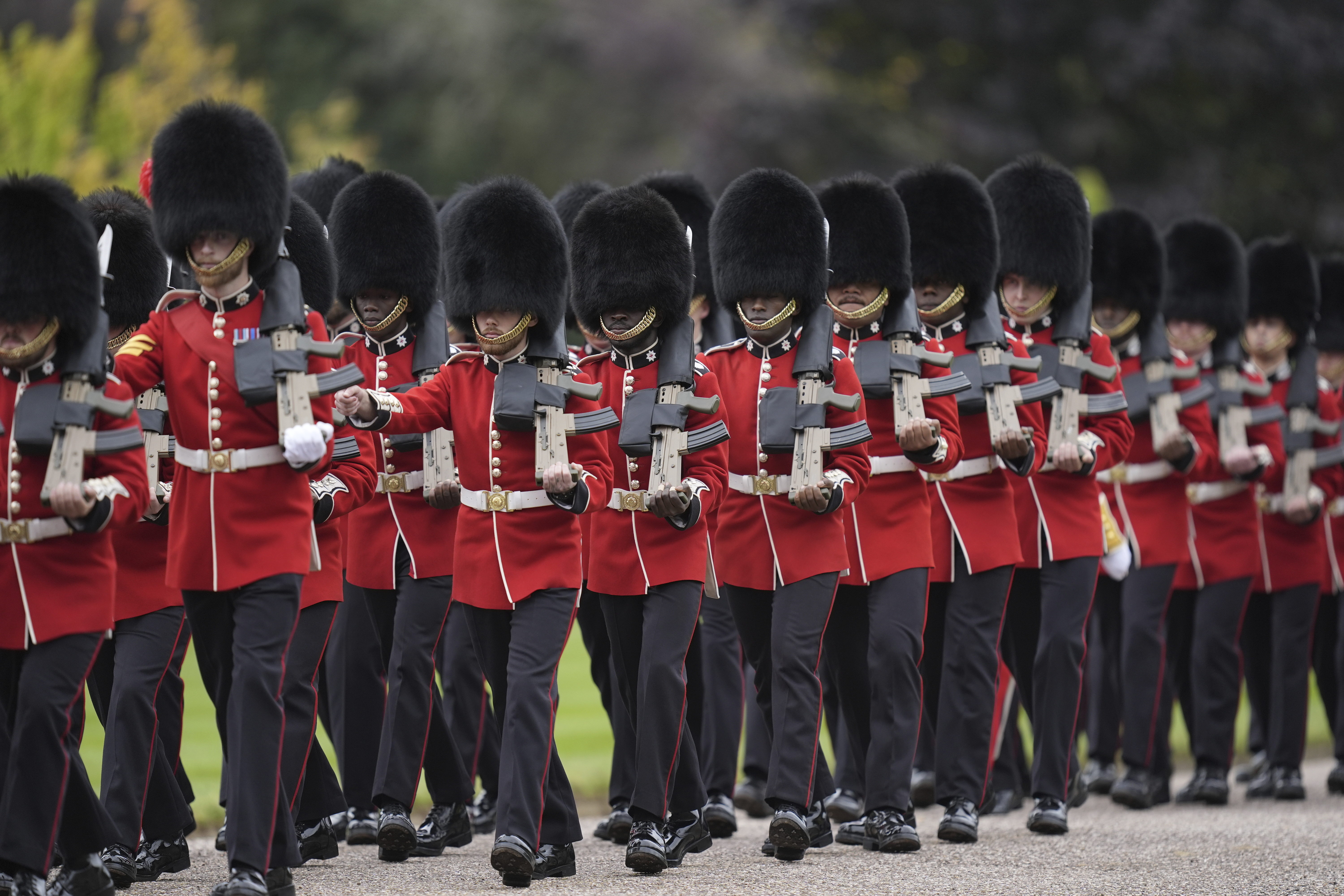Members of the Household Division Foot Guards line up along the route ahead of the carriage procession to Windsor Castle of President Donald Trump and first lady Melania Trump, in Windsor, England, Wednesday, Sept. 17, 2025. (Andrew Matthews - Pool PA)