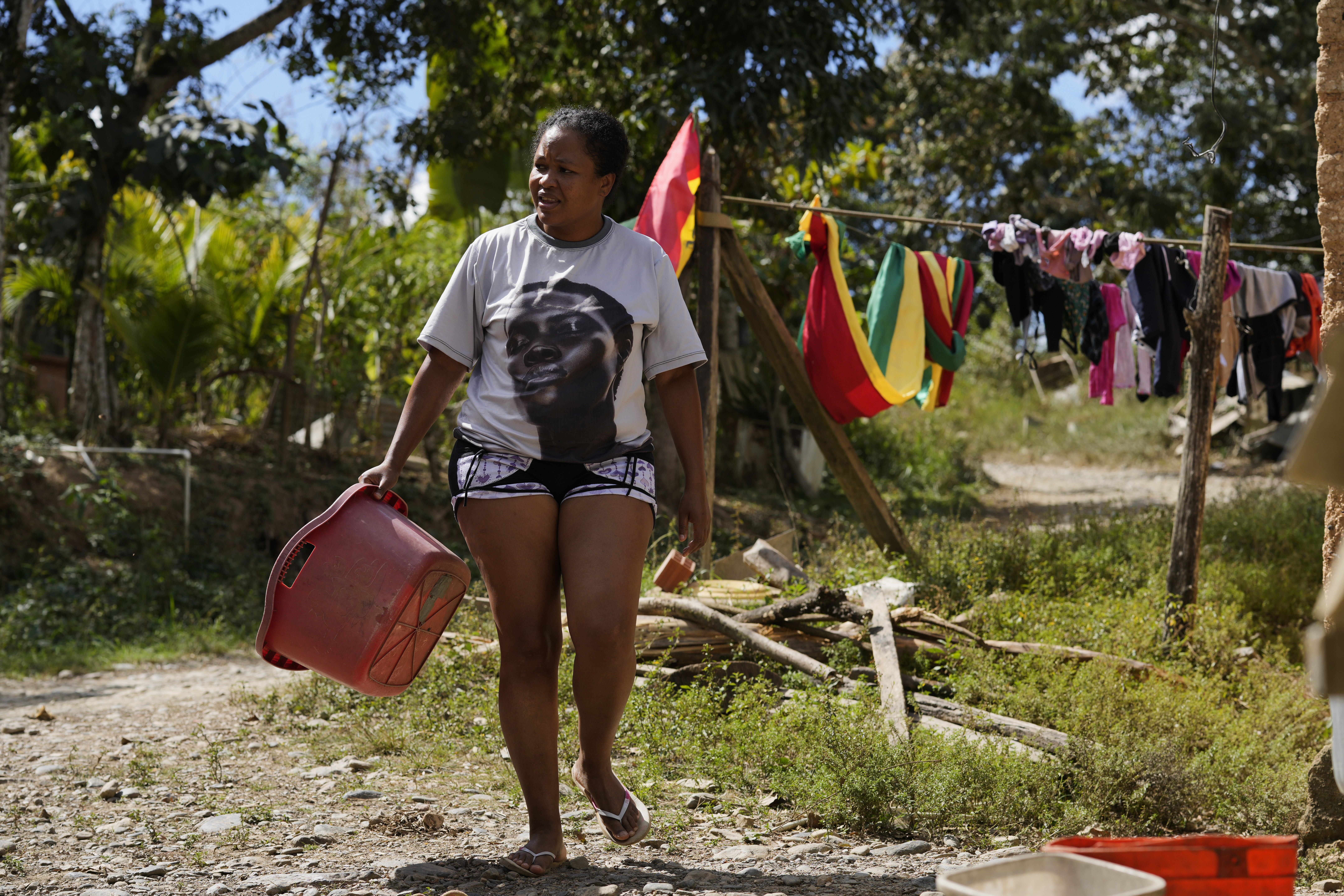 An Afro-Bolivian woman walks away after hanging laundry to dry, near Tocana, in Los Yungas region of Bolivia, Sunday, Aug. 3, 2025. (Juan Karita - AP)