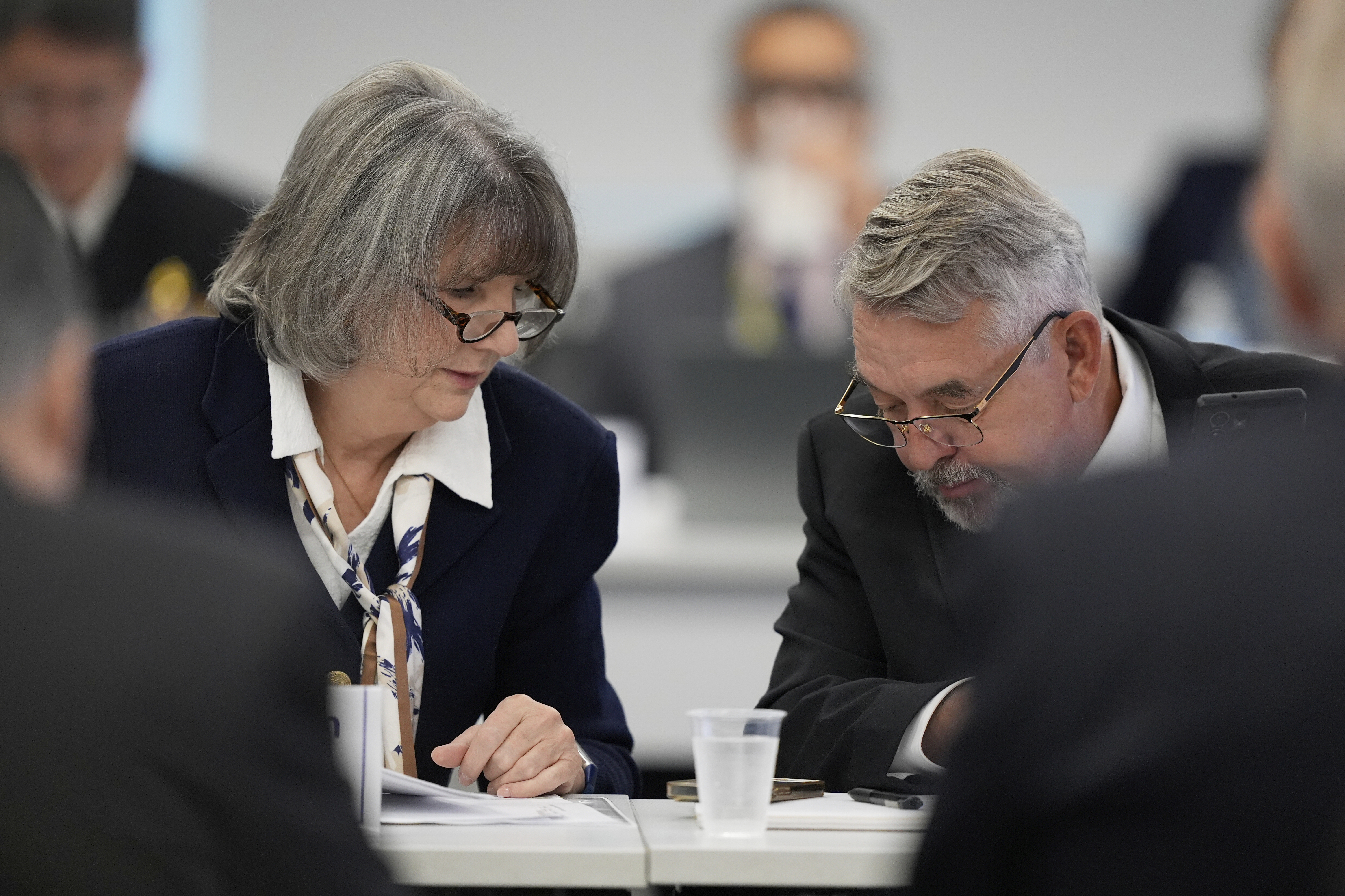 Committee members, Dr. Joseph Hibbeln, right, talks with Vicky Pebsworth, left, during a meeting of the Advisory Committee on Immunization Practices at the CDC on Thursday, Sept. 18, 2025, in Chamblee, Ga. (Brynn Anderson - AP)