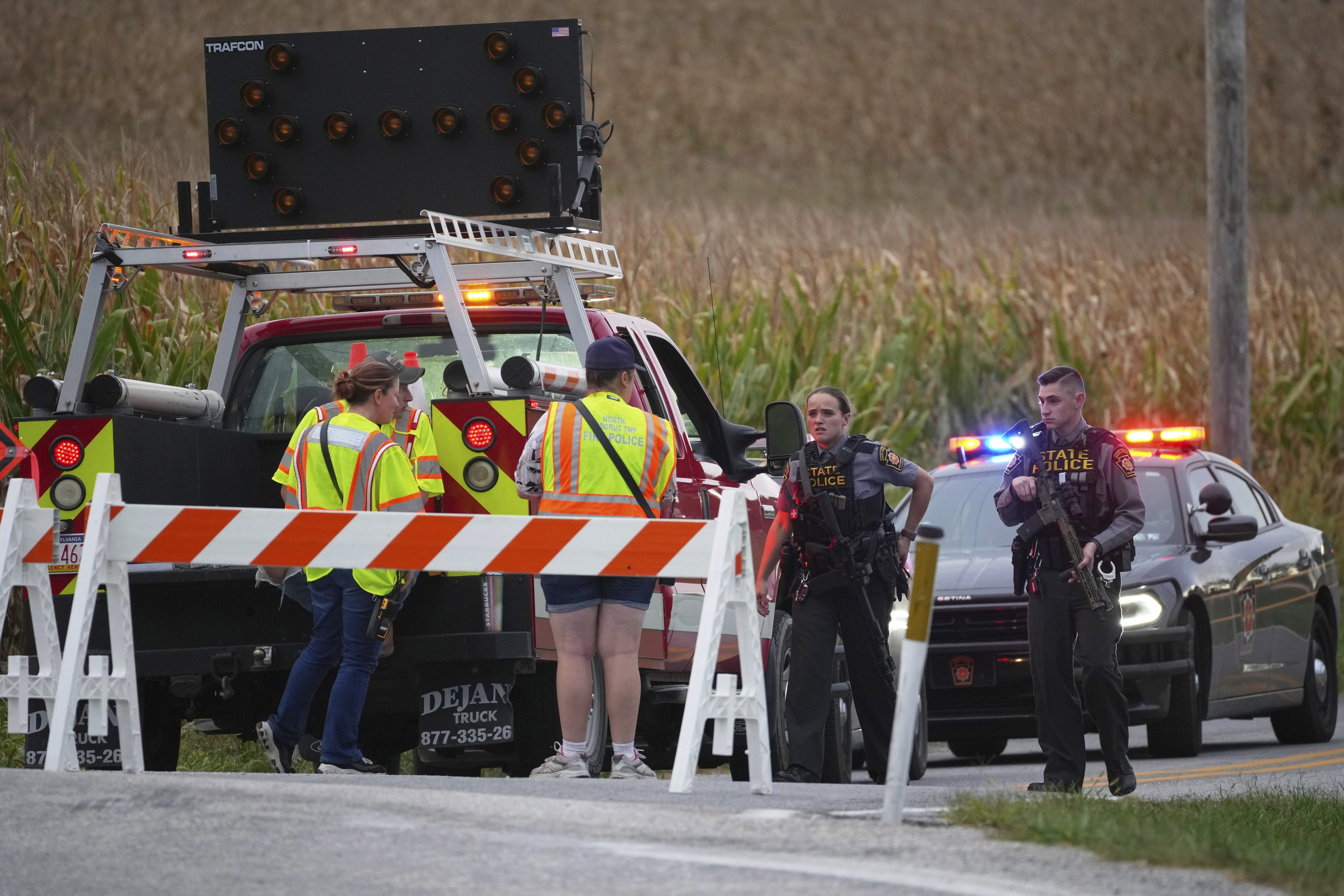 Pennsylvania state police troopers and emergency workers block a road after multiple police officers were shot and killed on Wednesday, Sept. 17, 2025, in North Codorus, Pa. (Matt Slocum - AP)