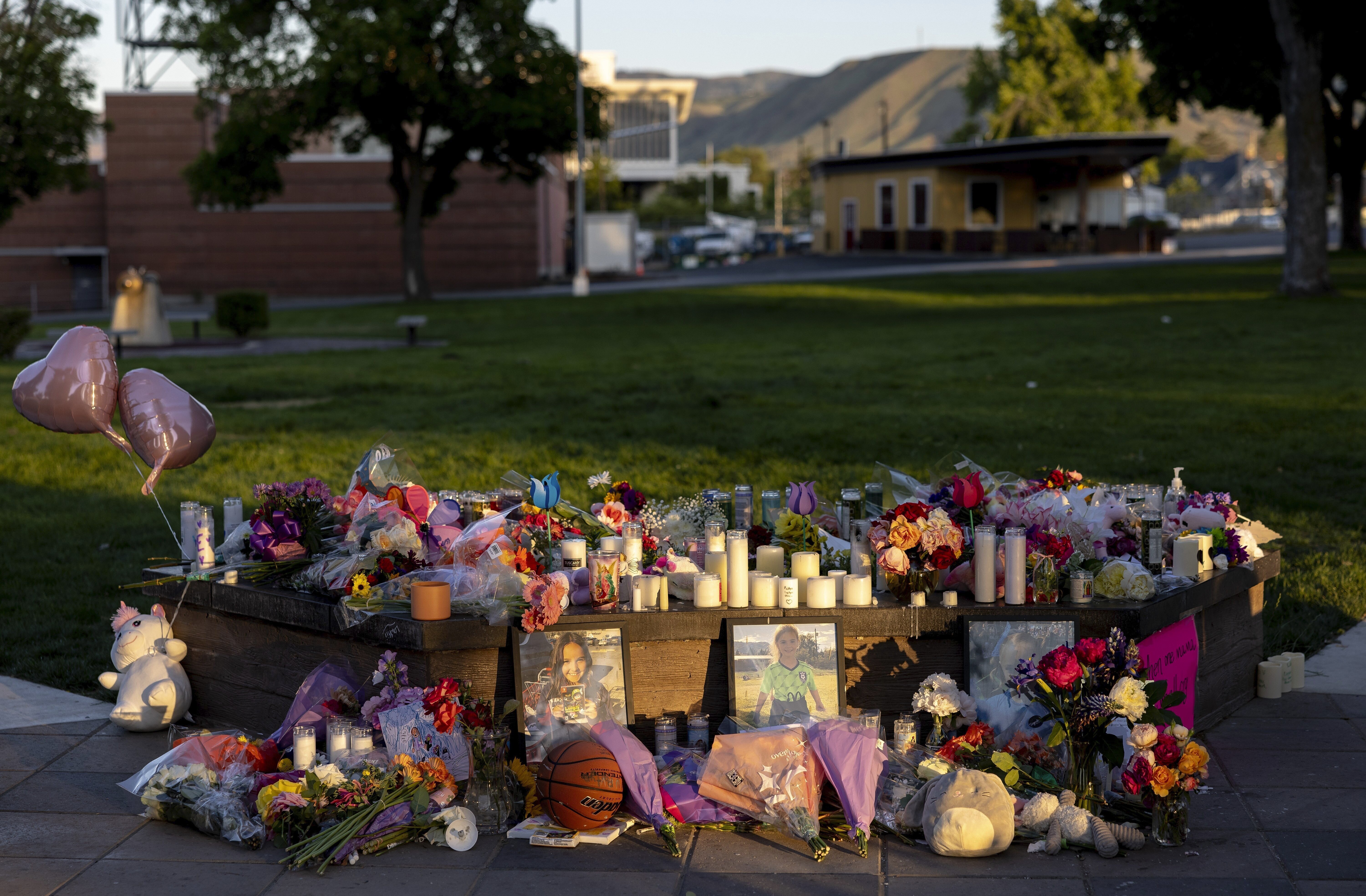 FILE - Pictures, flowers and candles mark a makeshift memorial, June 3, 2025, in Wenatchee, Wash., in honor of Olivia, Paityn and Evelyn Decker, who were found dead near Leavenworth after their father Travis Decker failed to return them after a scheduled visitation. (Nick Wagner - The Seattle Times)