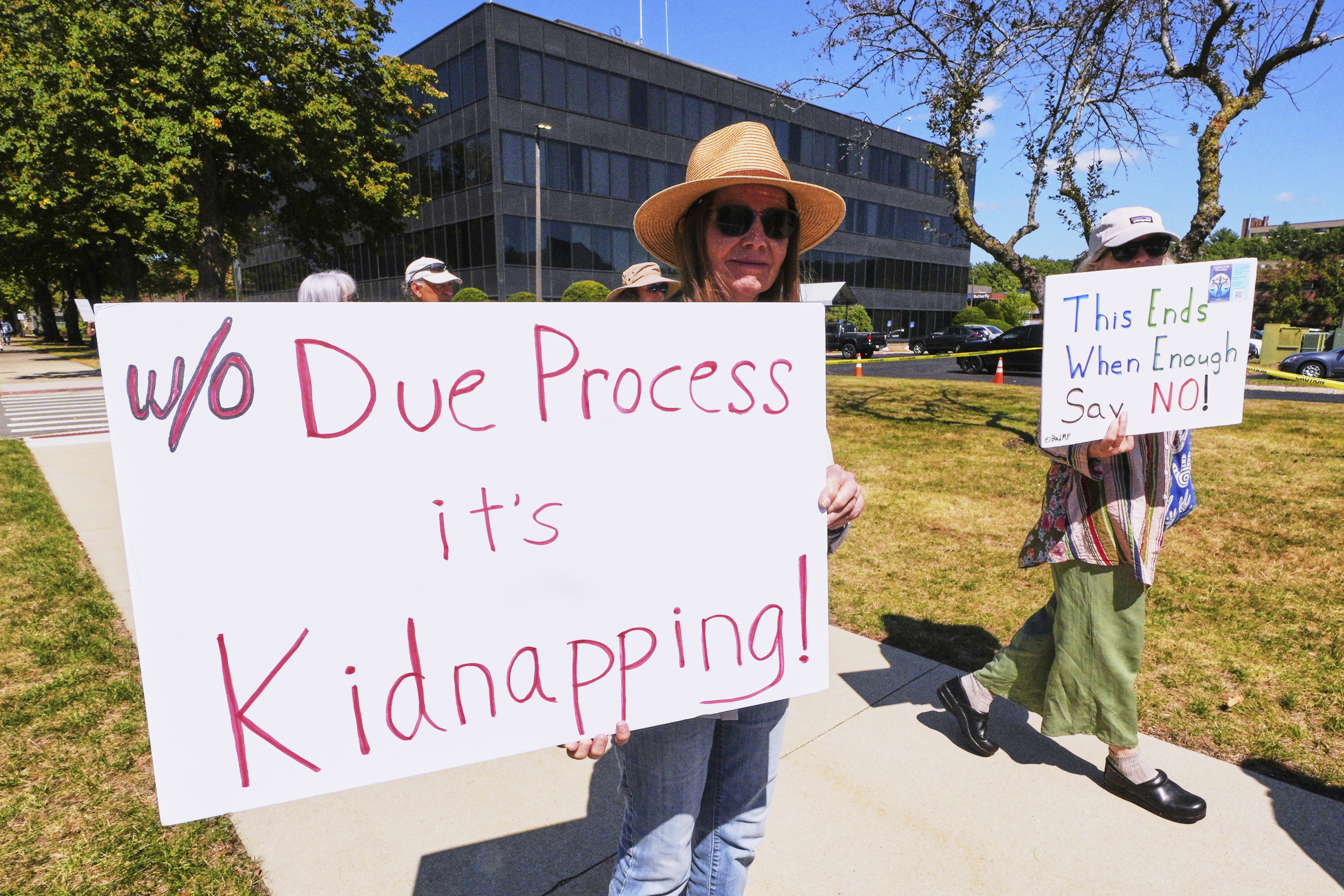 Protesters picket outside the U.S. Immigration and Customs Enforcement regional field office, Thursday, Sept. 11, 2025, in Burlington, Mass. (Charles Krupa - AP)