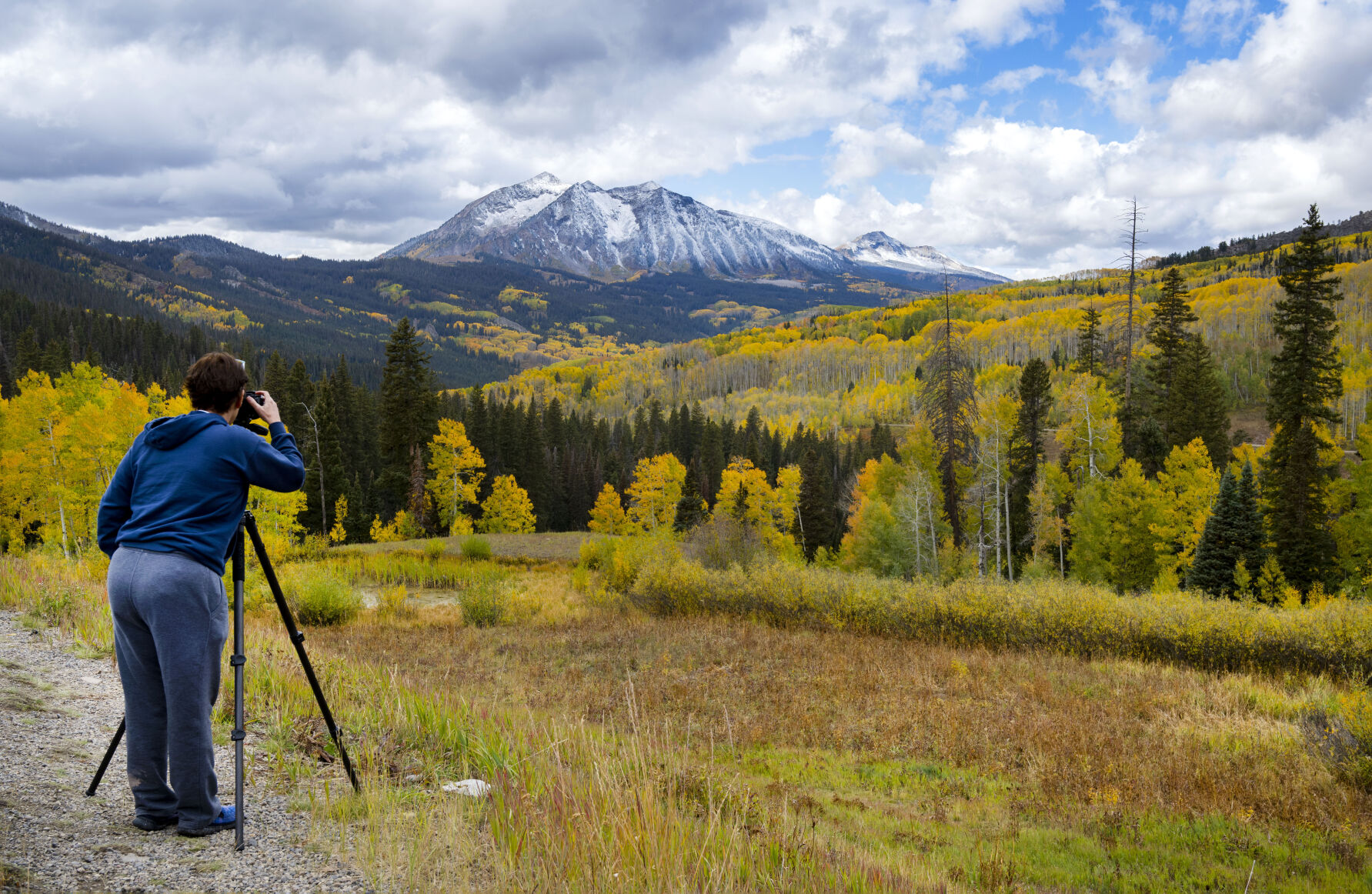 Jennifer Bartholomew from northern California captures the fall colors and fresh snow on Kebler Pass near Crested Butte, Colo., Tuesday, Oct. 2, 2023, after a storm Monday night capped the central mountains with snow. (The Gazette, Christian Murdock) (Christian Murdock/The Gazette)