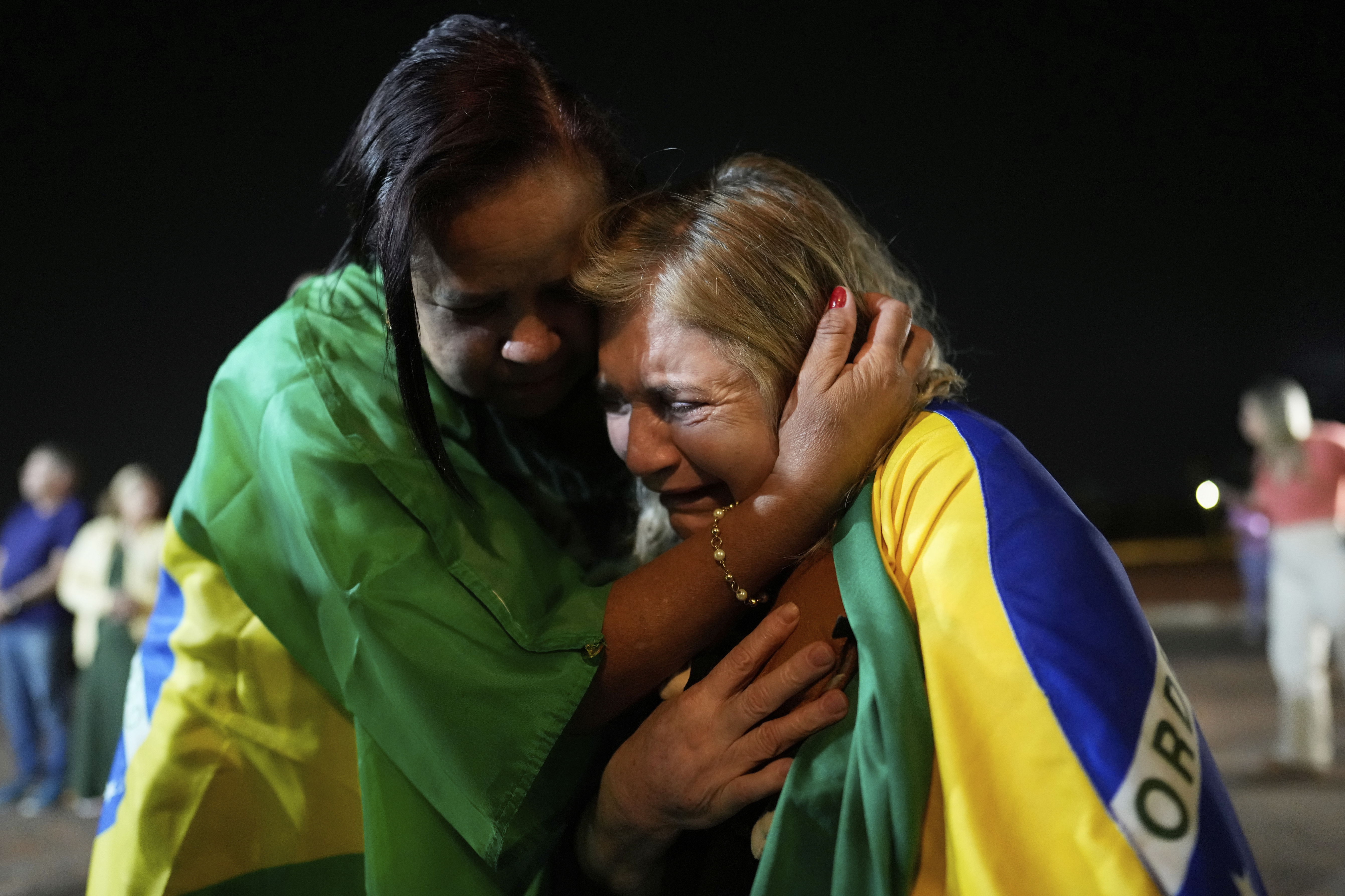 Supporters of former President Jair Bolsonaro cry during a vigil in his support near his home where he is under house arrest in Brasilia, Brazil, Thursday, Sept. 11, 2025. (Eraldo Peres - AP)