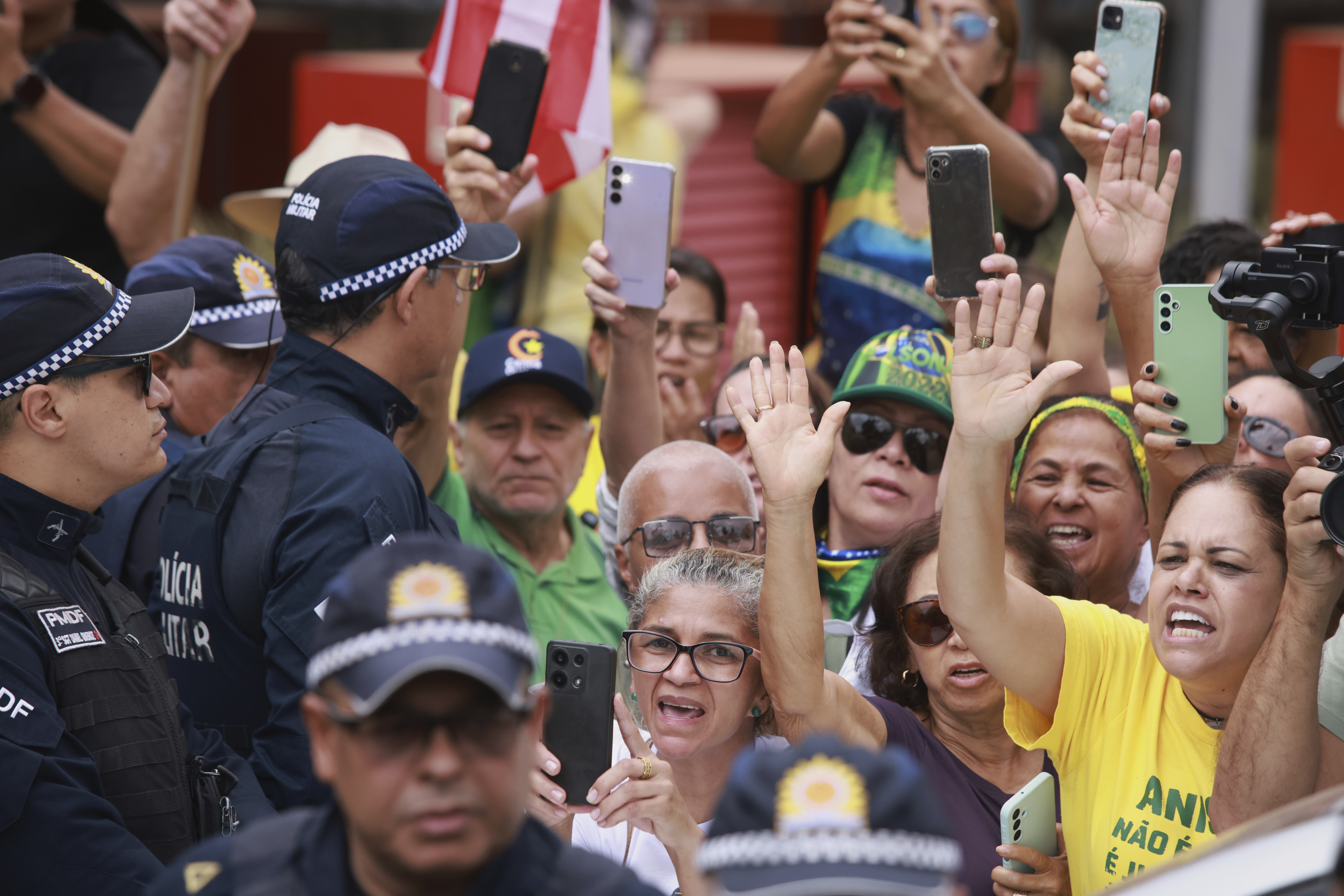 Supporters cheer as former President Jair Bolsonaro, temporarily allowed out of house arrest for medical treatment, departs a hospital in Brasilia, Brazil, Sunday, Sep. 14, 2025. (Luis Nova - AP)
