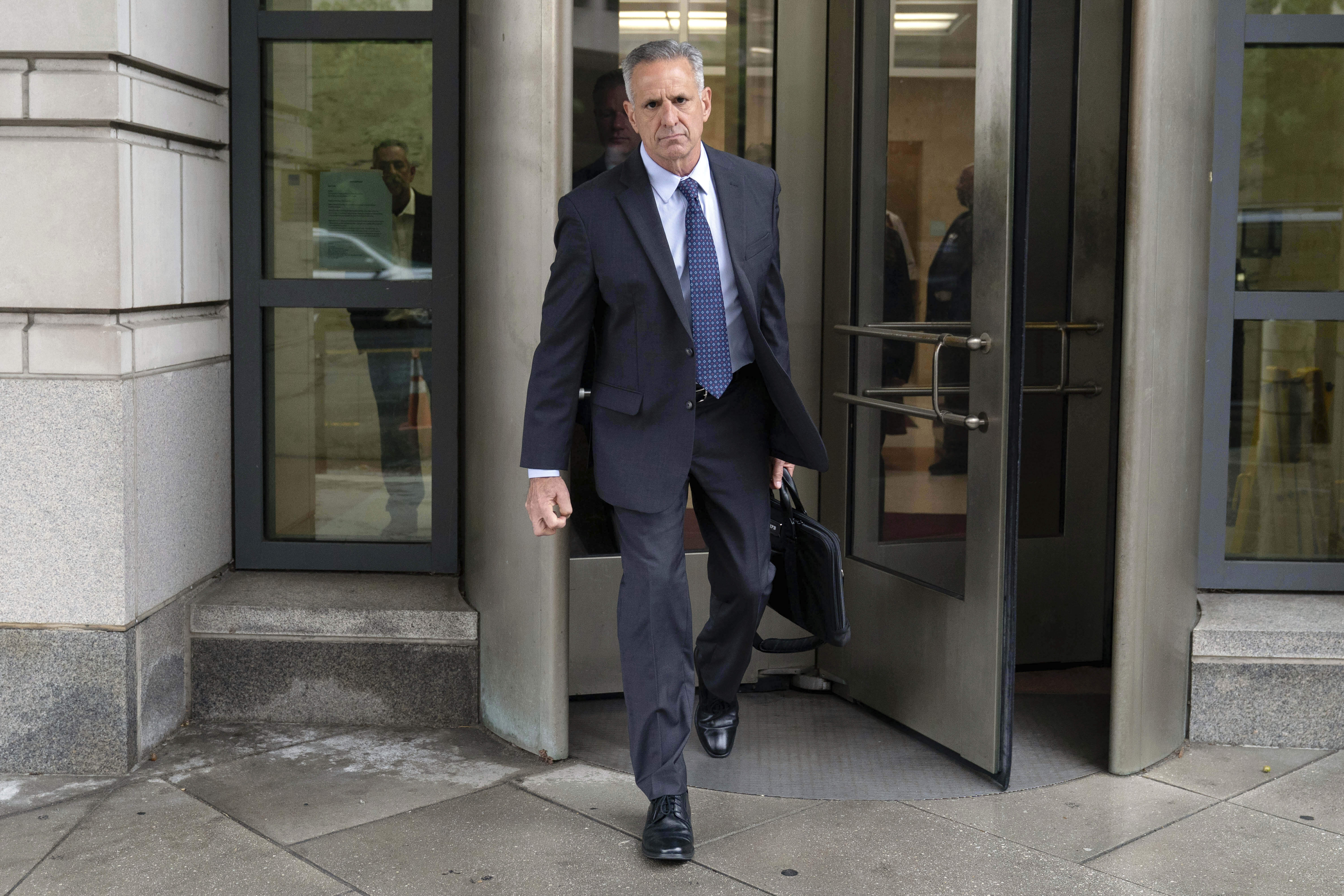 Retired Adm. Robert P. Burke, 63, walks out of the federal courthouse after being sentenced to six year in prison for his conviction on corruption charges, Tuesday, Sept. 16, 2025, in Washington. (Jose Luis Magana - FR159526 AP)