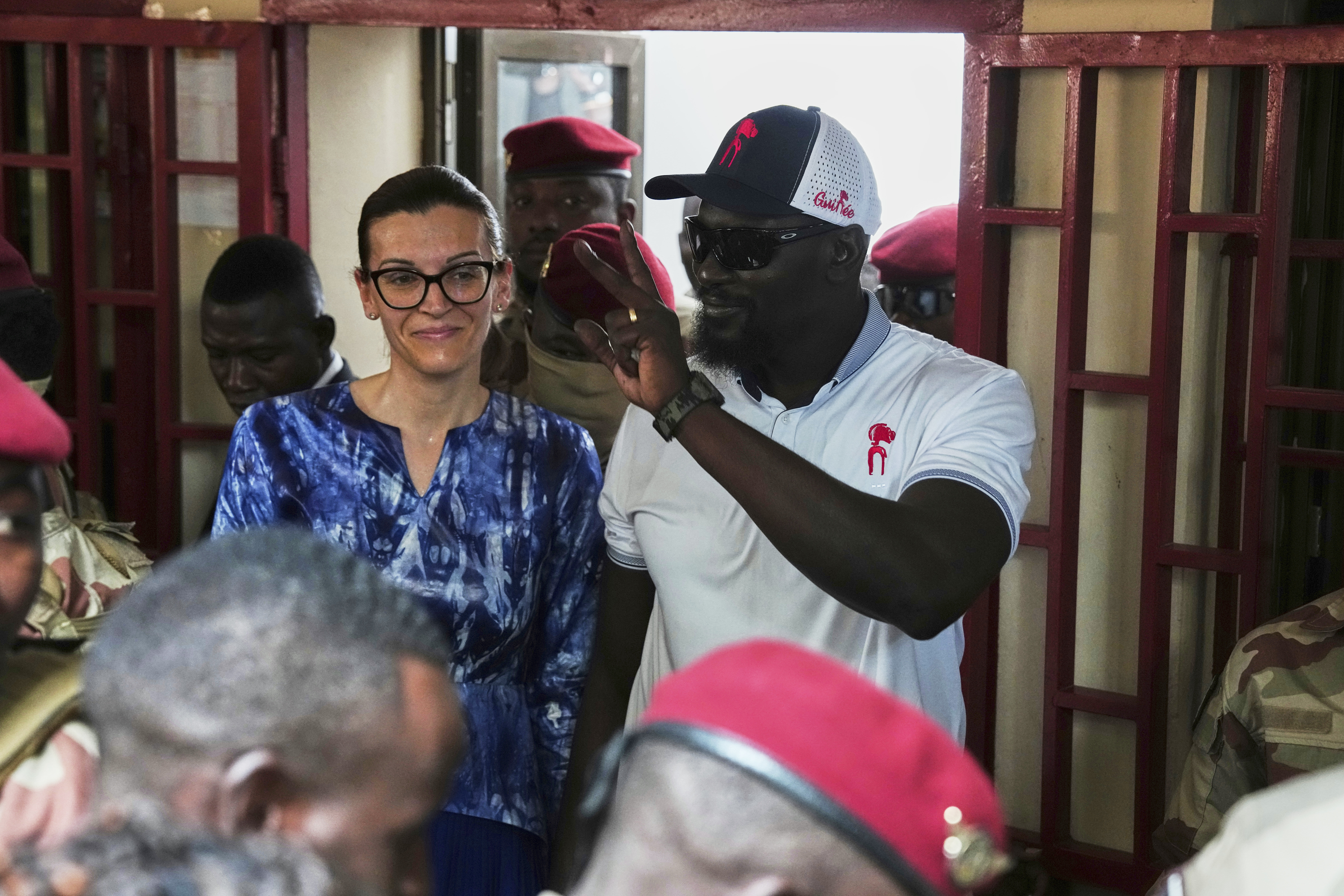 Guinea's interim President, Gen. Mamadi Doumbouya, departs with his wife after casting his vote in the constitutional referendum in Conakry, Guinea, Sunday, Sept. 21, 2025. (Misper Apawu - AP)