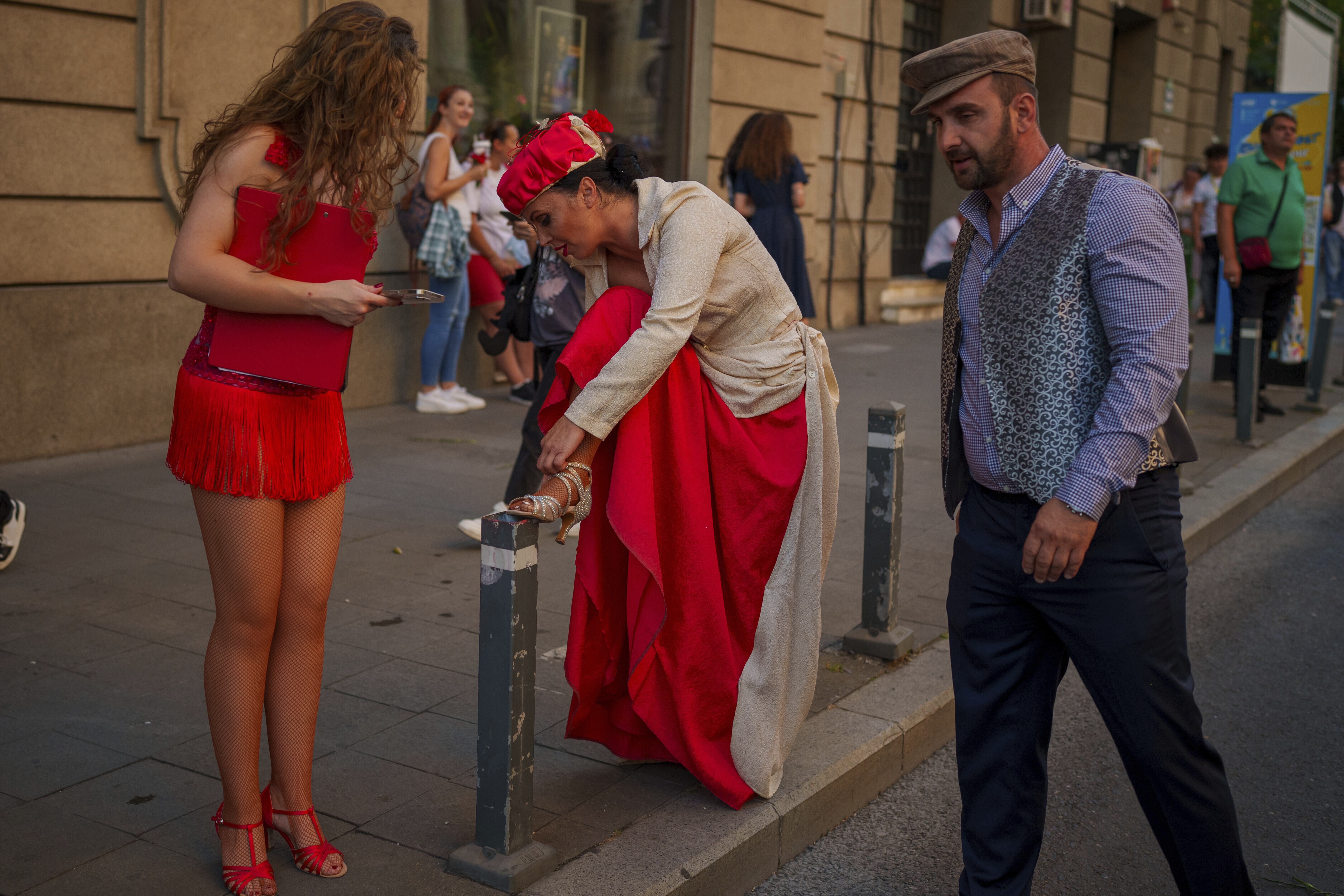 An artist of the Bucharest Metropolitan Circus adjusts her shoe during an event marking the day when the Romanian capital was first mentioned in historical records, 566 years ago, in Bucharest, Romania, Saturday, Sept. 20, 2025. (Vadim Ghirda - AP)