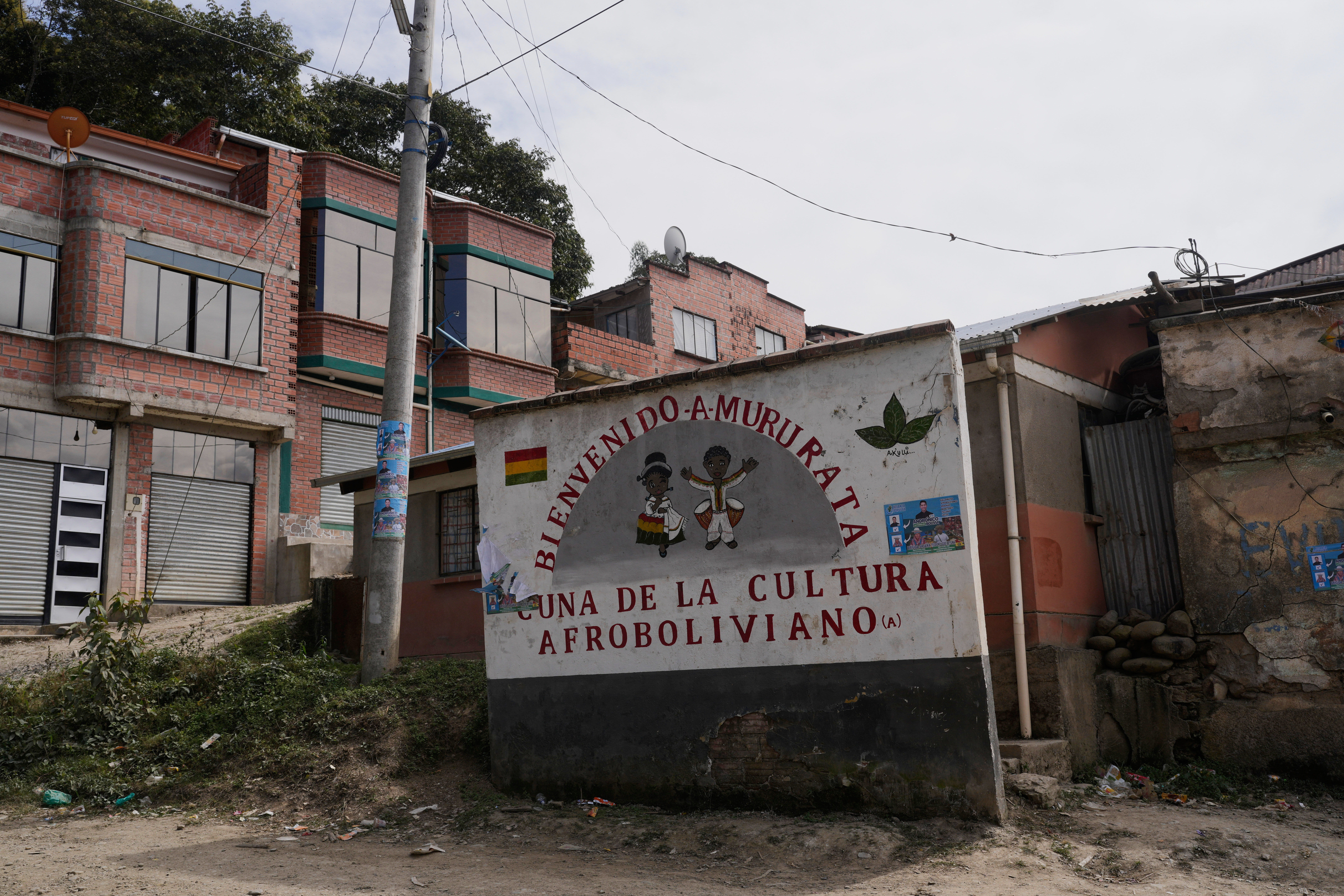 A sign with a message that reads in Spanish: “Welcome to Mururata, cradle of Afro-Bolivian culture” stands at the entrance of Mururata, Bolivia, Sunday, Aug. 3, 2025. (Juan Karita - AP)