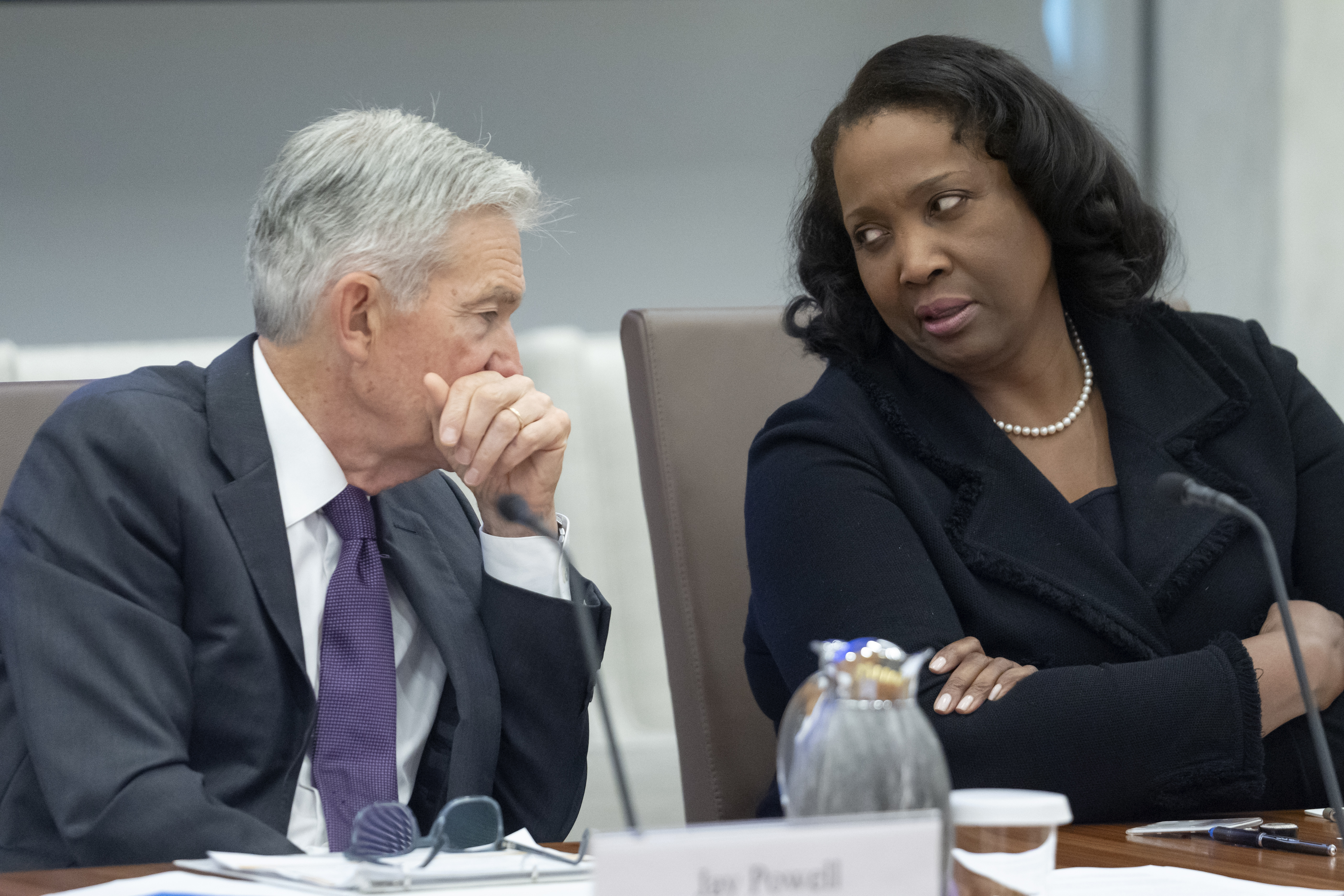FILE - Federal Reserve Chairman Jerome Powell, left, talks with Board of Governors member Lisa Cook, right, during an open meeting of the Board of Governors at the Federal Reserve, June 25, 2025, in Washington. (Mark Schiefelbein - AP)