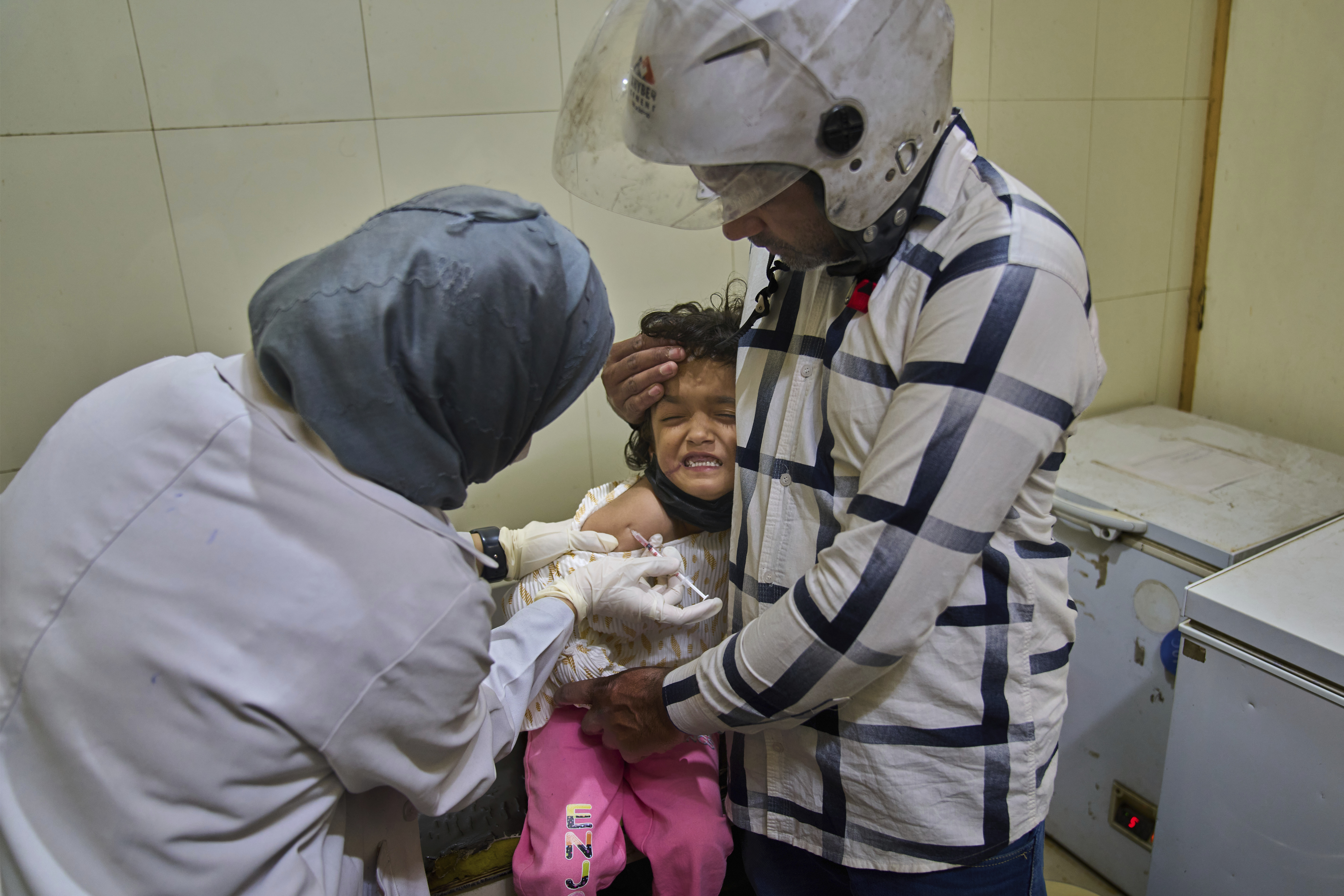 Rehmat Ashraf, 6, who was attacked by a dog outside her house, grimaces as she receives a dose of vaccine at the anti-rabies clinic at a hospital in Srinagar, Indian controlled Kashmir, Thursday, Sept. 18, 2025. (Dar Yasin - AP)