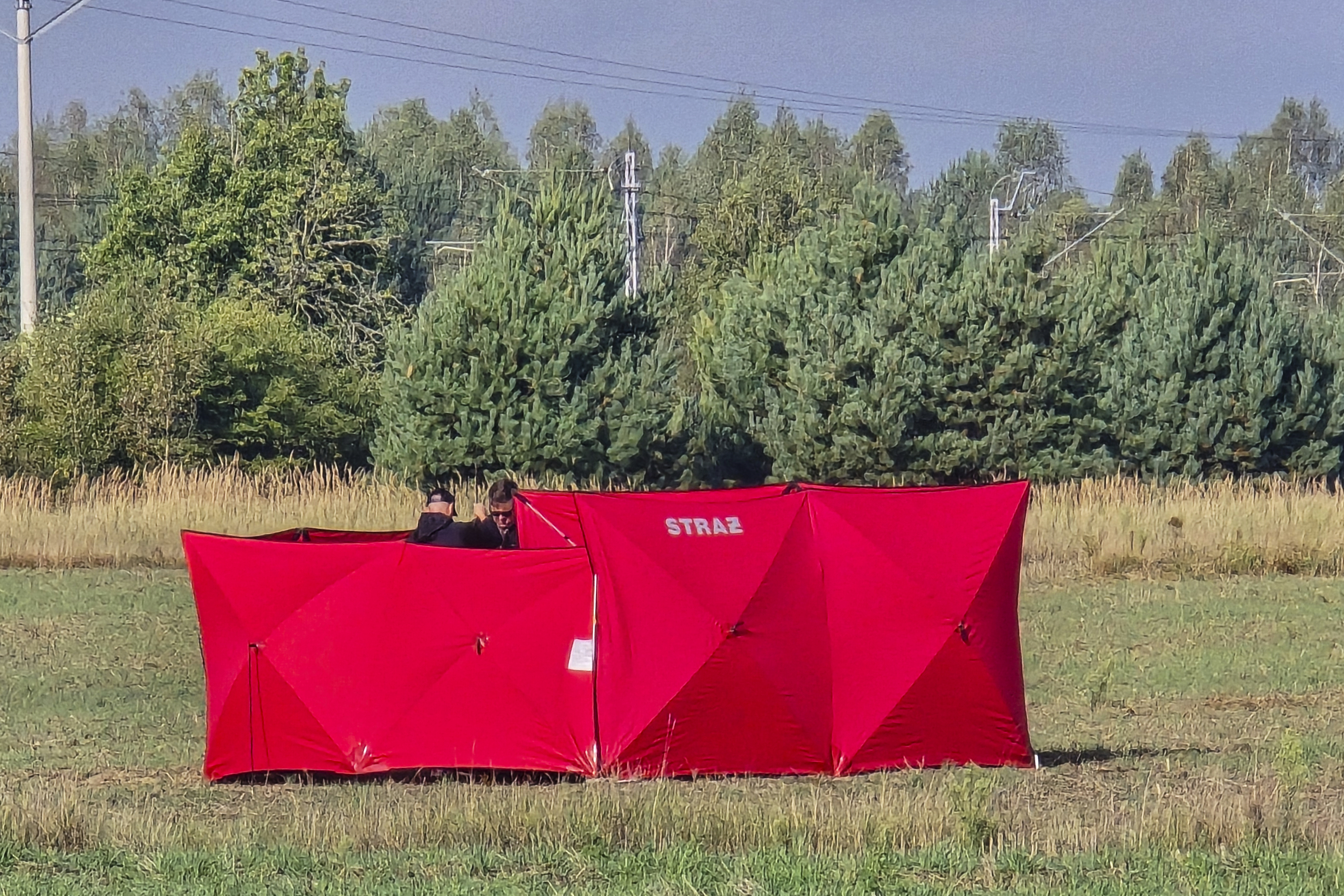 Firefighters secure parts of a damaged UAV shot down by Polish authorities at a site in Czosnowka near Biala Podlaska, Poland, Wednesday, Sept. 10, 2025. (Piotr Pyrkosz - AP)
